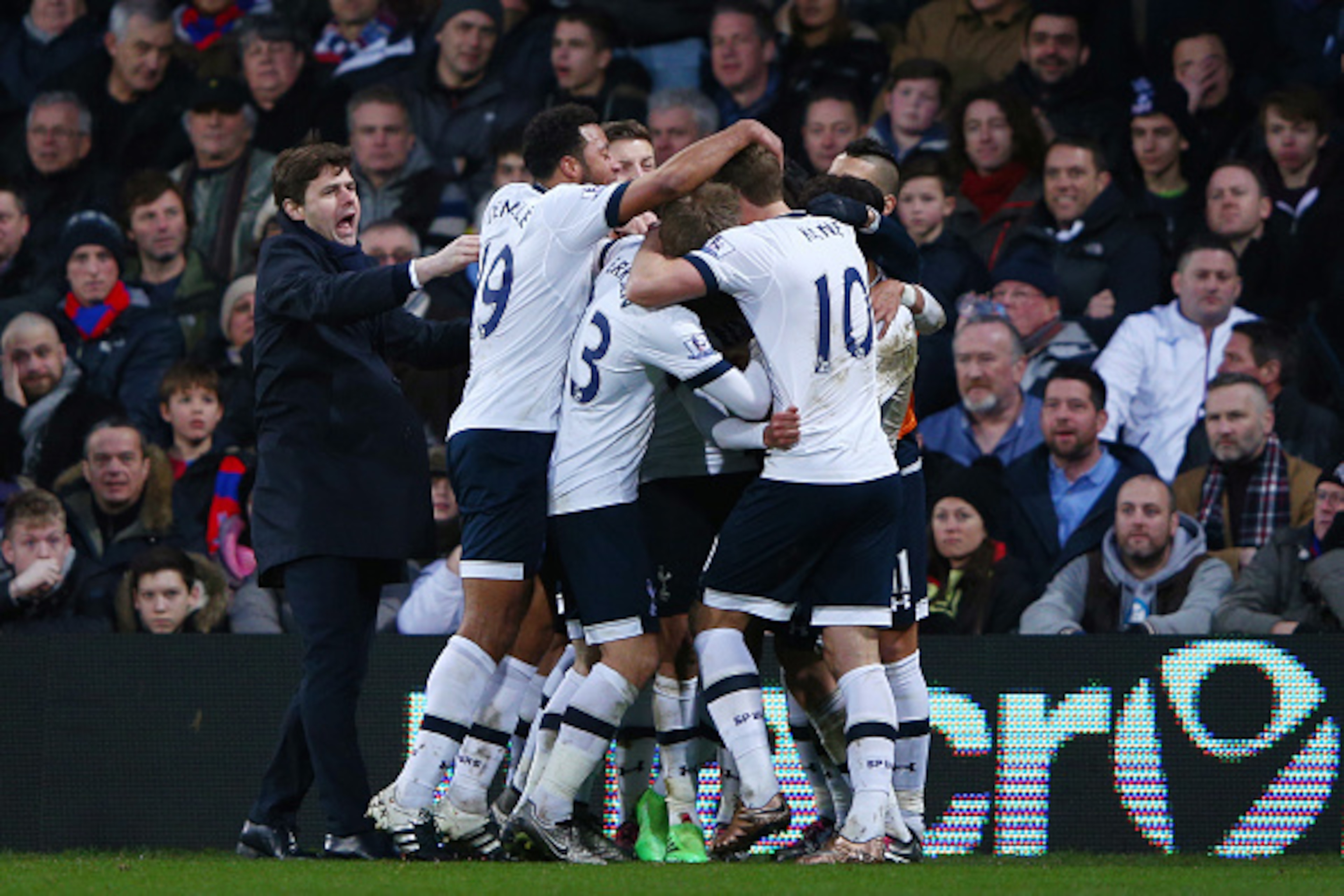 LONDON, ENGLAND - JANUARY 23: Dele Alli (obscured) of Tottenham Hotspur celebrates scoring his team's second goal with his team mates and Mauricio Pochettino (1st L) during the Barclays Premier League match between Crystal Palace and Tottenham Hotspur at 