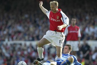 21 Apr 2002:  Dennis Bergkamp of Arsenal is tackled by Tommy Miller of Ipswich Town during the FA Barclaycard Premiership match between Arsenal and Ipswich Town at Highbury, London.  DIGITAL IMAGE Mandatory Credit: Phil Cole/Getty Images
