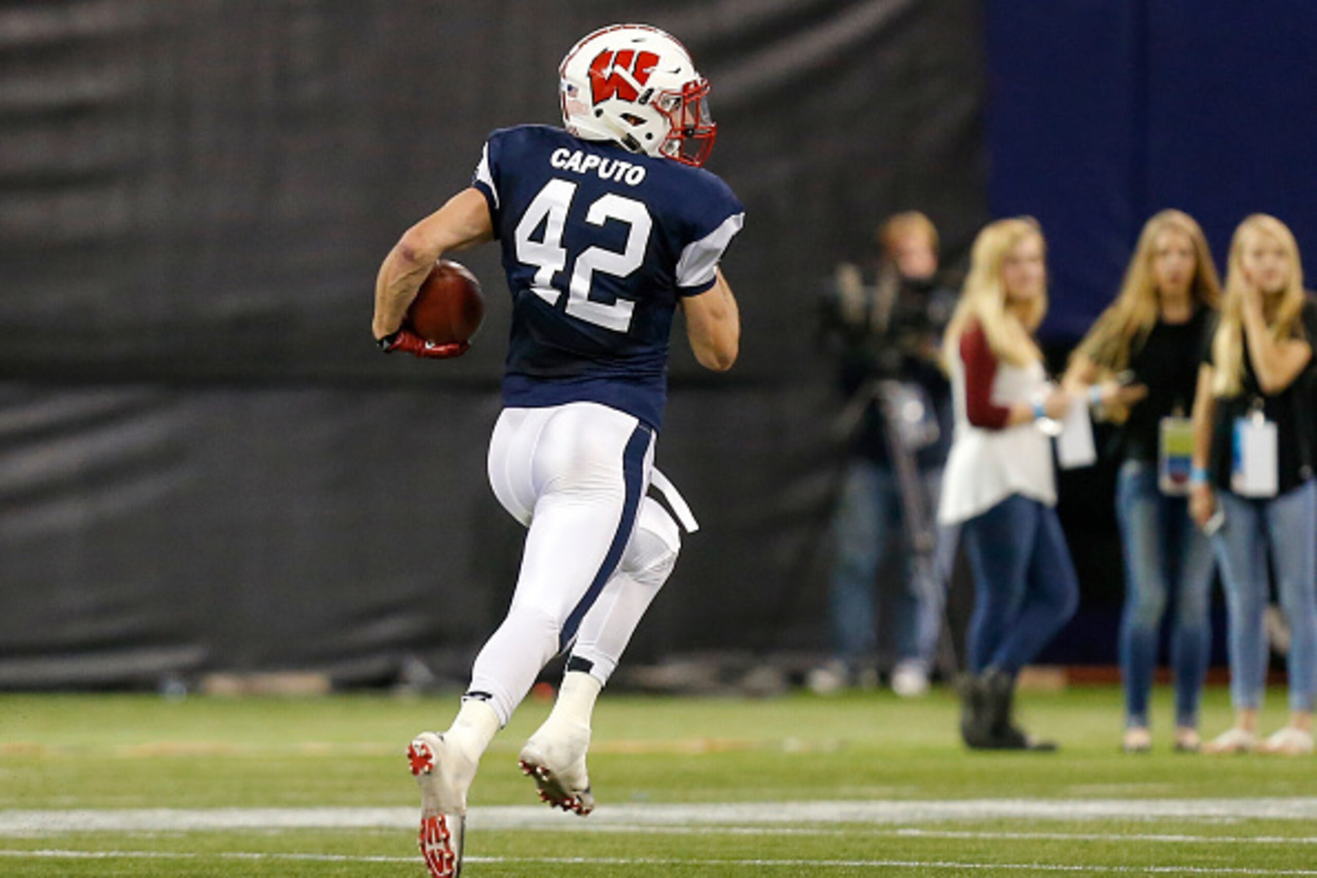 ST. PETERSBURG, FL - JANUARY 23:  Michael Caputo #42 from Wisconsin playing on the West Team returns an interception against the East Team during the first half of the East West Shrine Game at Tropicana Field on January 23, 2016 in St. Petersburg, Florida