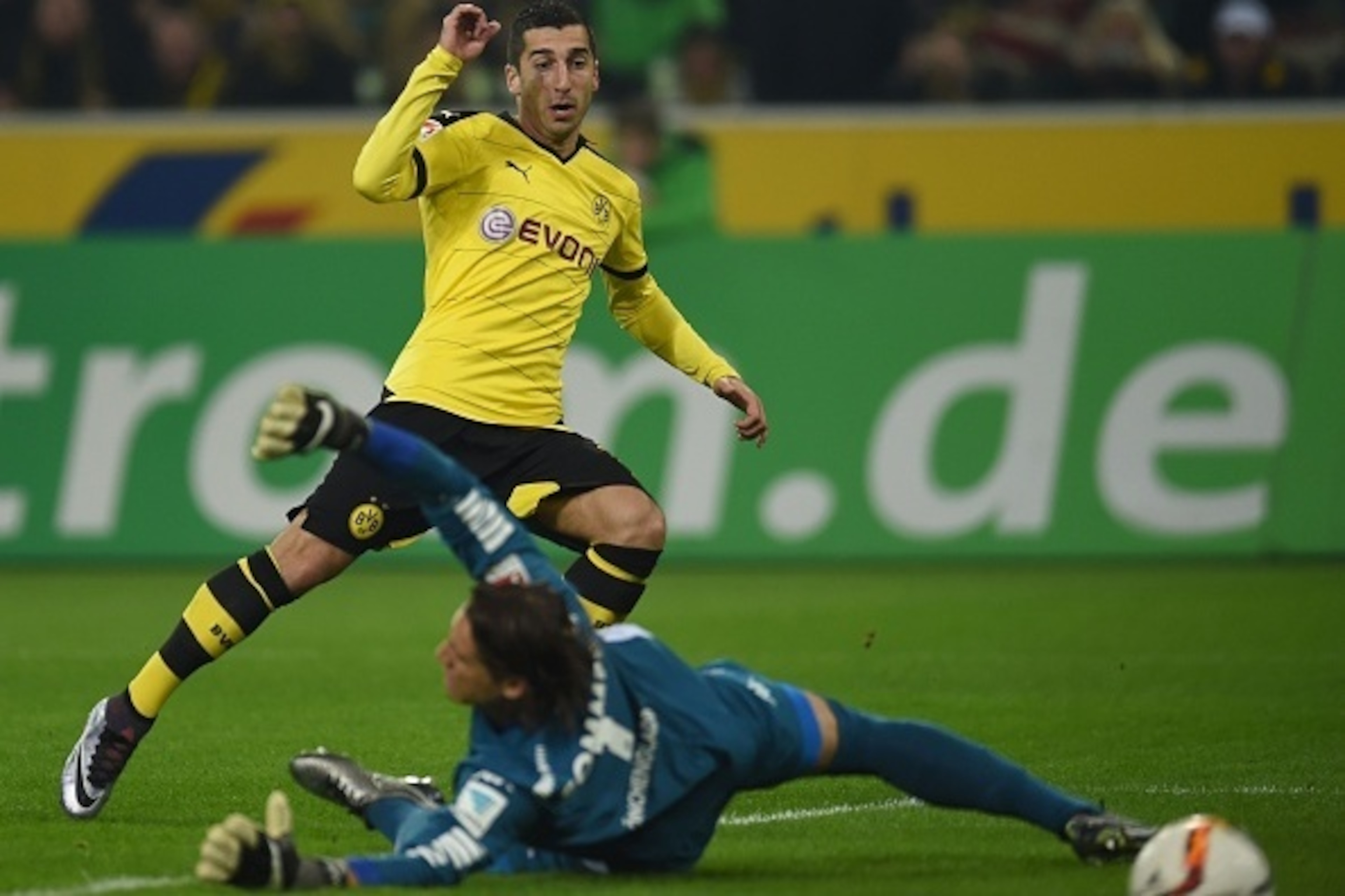 Dortmund's Armenian midfielder Henrikh Mkhitaryan (L) and Moenchengladbach's Swiss goalkeeper Yann Sommer vie for the ball during the German first division football Bundesliga match Moenchengladbach vs Dortmund in Moenchengladbach, western Germany, on Jan