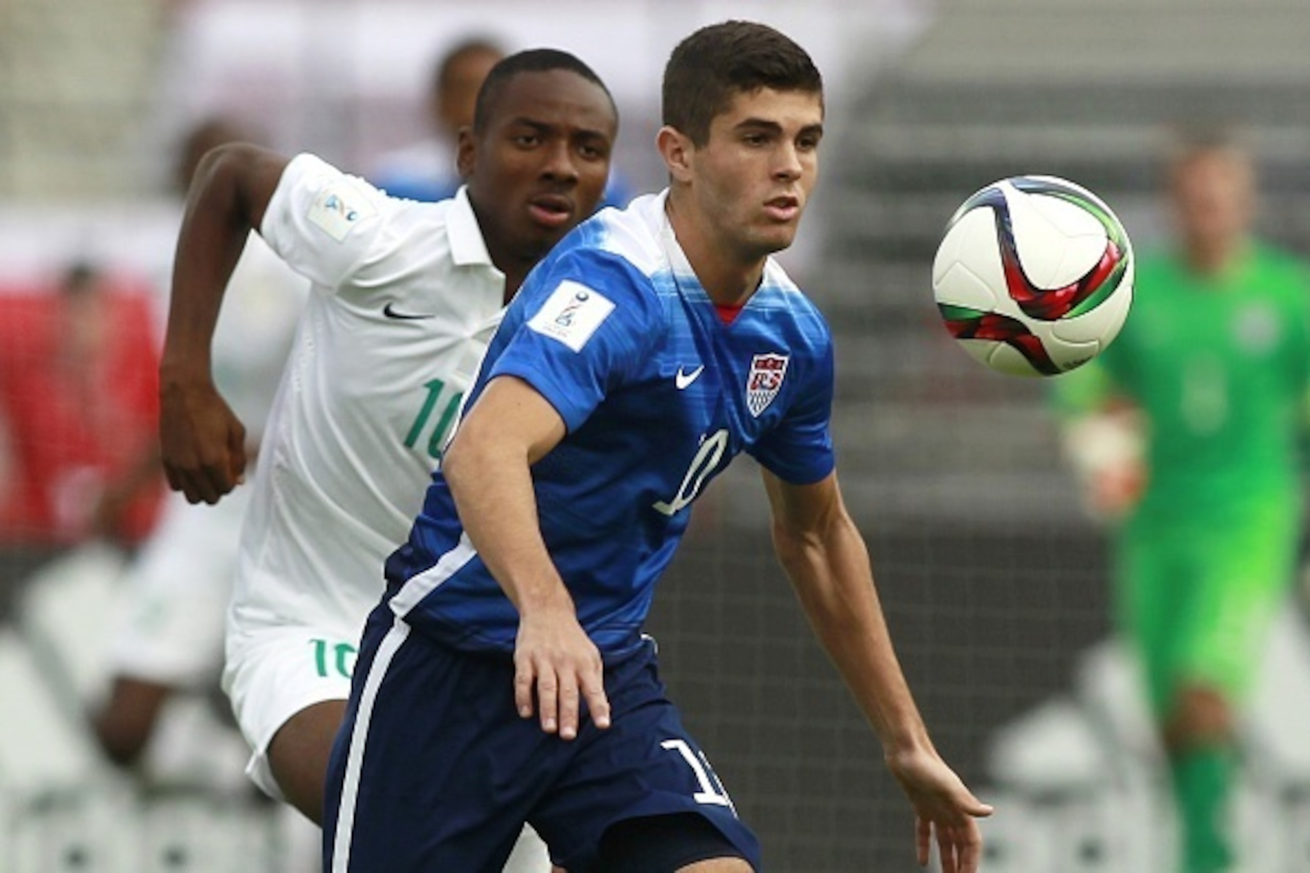 US player  Christian Pulisic (R) vie the ball with Nigeria Keleshi Nwala (L)  during an Under 17 World Cup football match between Nigeria and the United States at the Estadio Nacional in Santiago on October 17, 2015.AFP PHOTO/MARCELO HERNANDEZ/PHOTOSPORT 