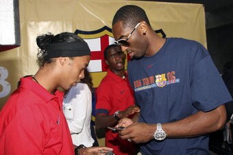 HOLLYWOOD - AUGUST 5:  (L-R)  Ronaldinho of Brazil and Kobe Bryant of the Los Angeles Lakers speak at Nike European Club Champion FC Barcelona Rally at Hollywood and Highland on August 5, 2006 in Hollywood, California.  (Photo Frederick M. Brown/ Getty Im