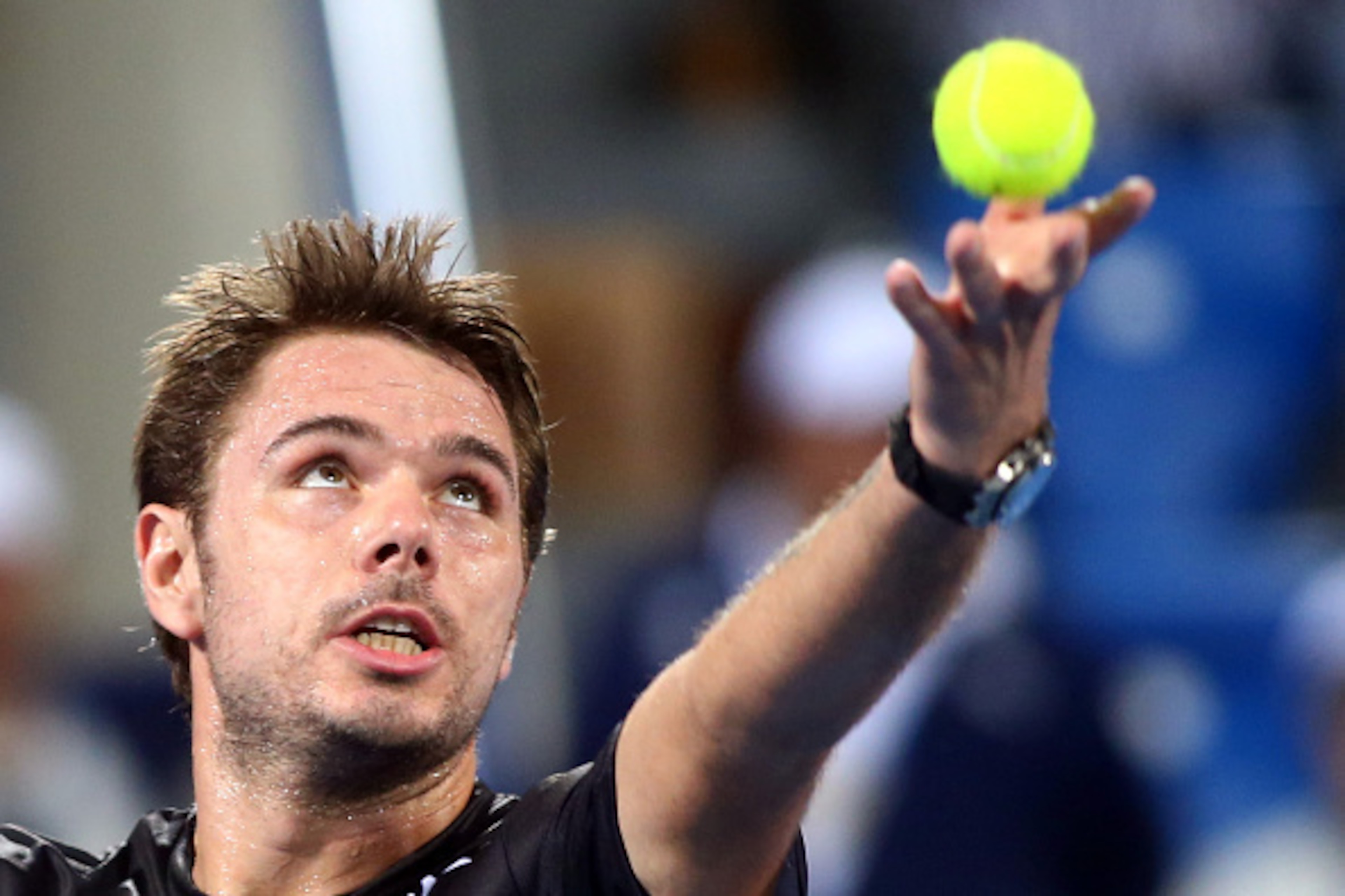 Swiss Stan Wawrinka serves the ball to Canadian Milos Raonic during their semi-final match in the Mubadala World Tennis Championship in Abu Dhabi on January 1, 2016. / AFP / MARWAN NAAMANI        (Photo credit should read MARWAN NAAMANI/AFP/Getty Images)