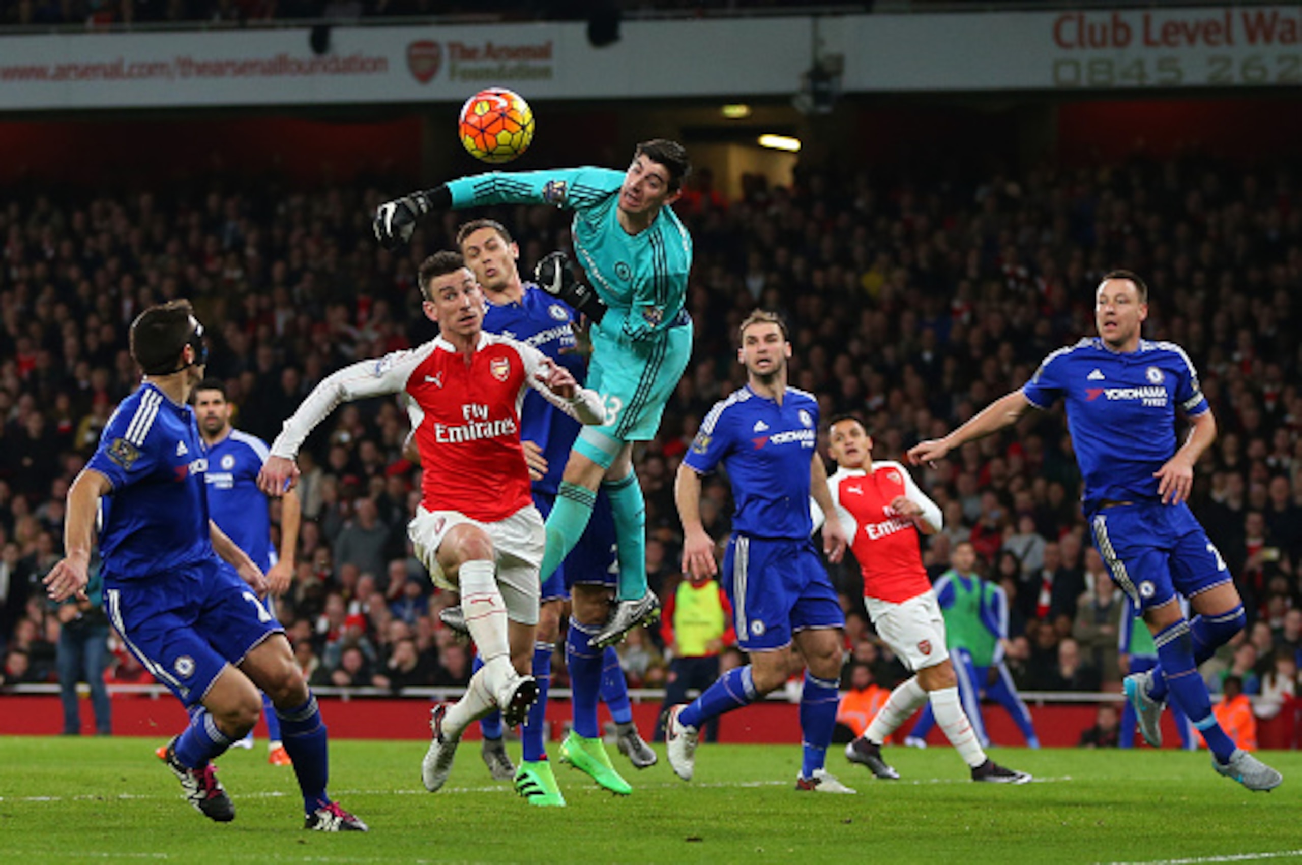 LONDON, ENGLAND - JANUARY 24:  Goalkeeper Thibaut Courtois of Chelsea punches away a shot during the Barclays Premier League match between Arsenal and Chelsea at the Emirates Stadium on January 24, 2016 in London, England.  (Photo by Catherine Ivill - AMA