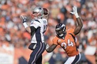Jan 24, 2016; Denver, CO, USA; New England Patriots quarterback Tom Brady (12) passes with Denver Broncos outside linebacker DeMarcus Ware (94) closing in during the first half in the AFC Championship football game at Sports Authority Field at Mile High. 