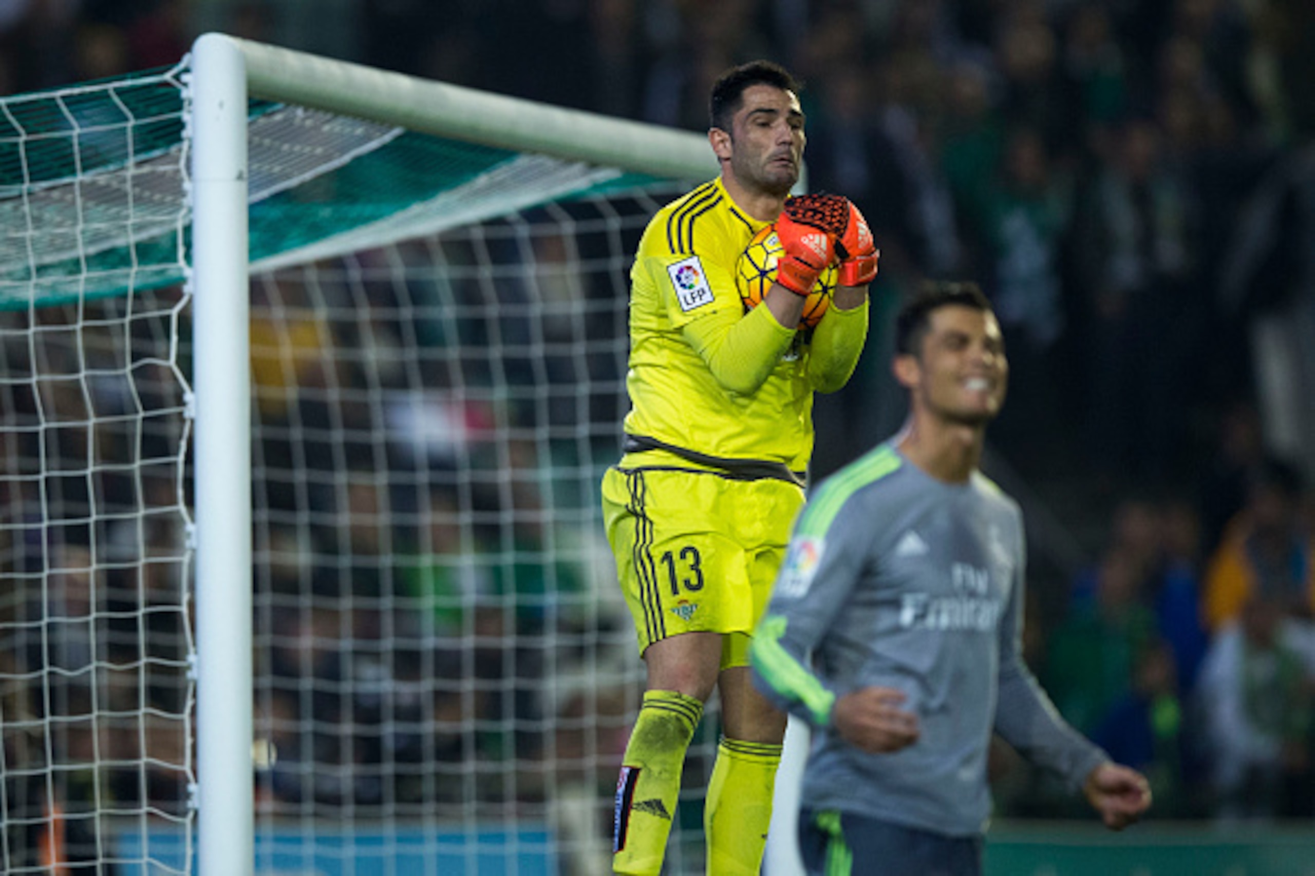 SEVILLE, SPAIN - JANUARY 24: Goalkeeper Antonio Adan (L) of Real Betis Balompie stops the ball striked by Cristiano Ronaldo (R) of Real Madrid CF during the La Liga match between Real Betis Balompie and Real Madrid CF at Estadio Benito Villamarin on Janu SEVILLE, SPAIN - JANUARY 24: Goalkeeper Antonio Adan (L) of Real Betis Balompie stops the ball striked by Cristiano Ronaldo (R) of Real Madrid CF during the La Liga match between Real Betis Balompie and Real Madrid CF at Estadio Benito Villamarin on Janu