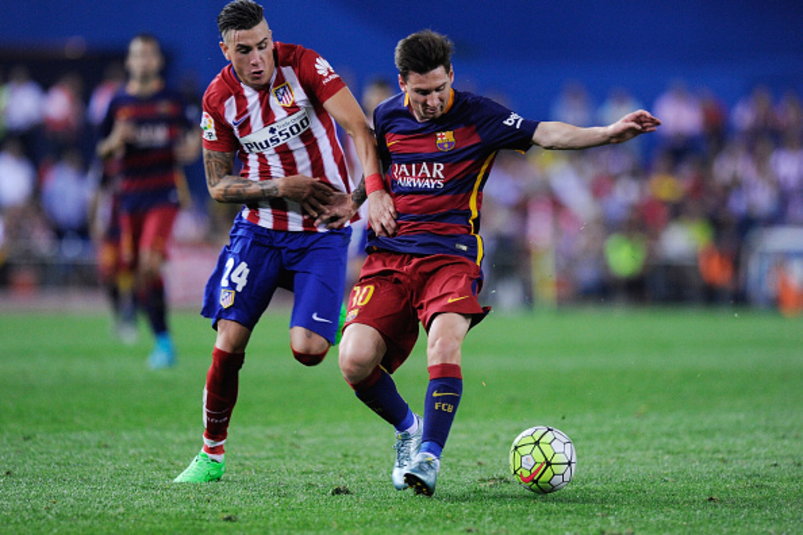 MADRID, SPAIN - SEPTEMBER 12:  Lionel Messi of FC Barcelona is fouled by Jose Maria Gimenez of Club Atletico de Madrid during the La Liga match between Club Atletico de Madrid and FC Barcelona at Vicente Calderon Stadium on September 12, 2015 in Madrid, S