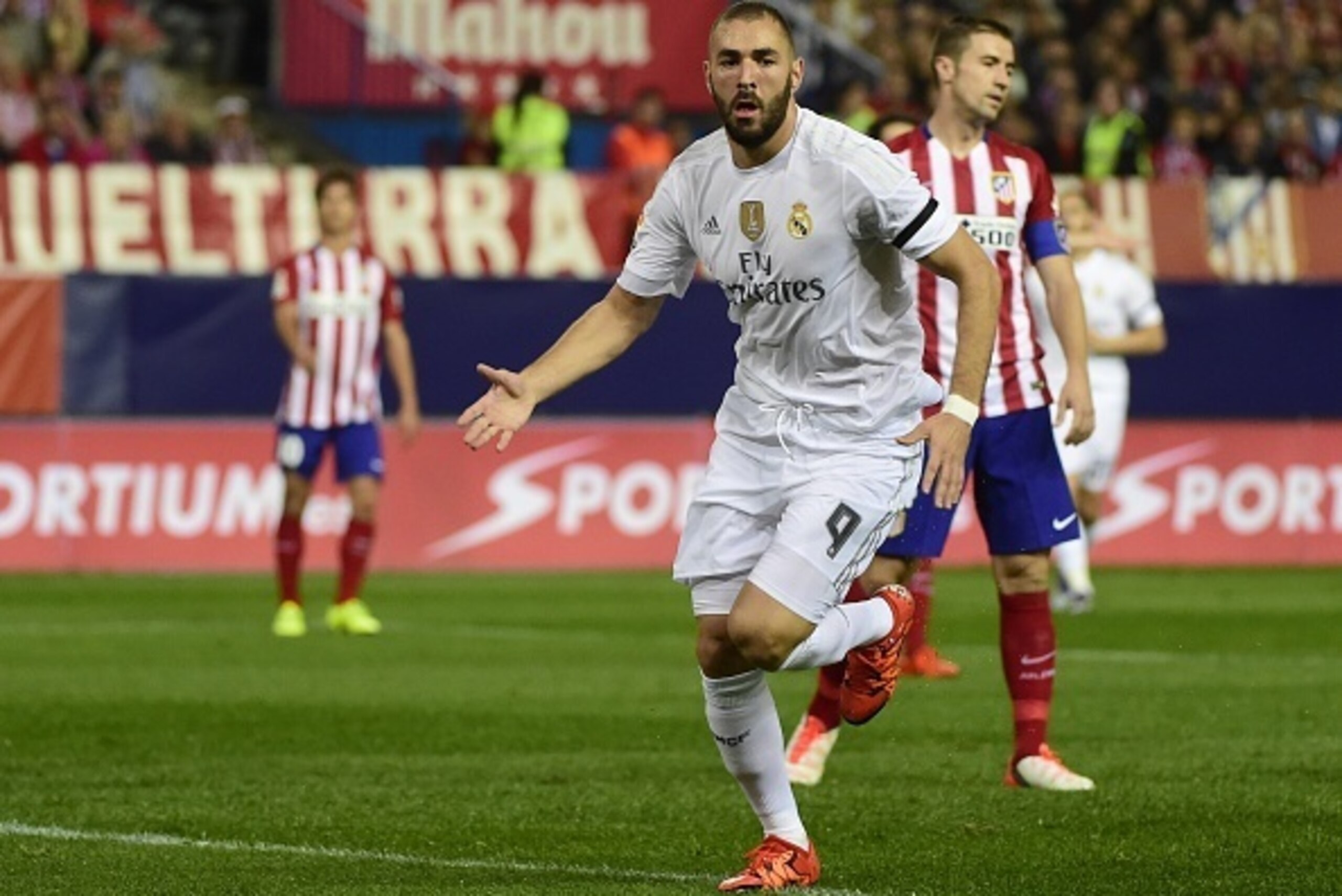 Real Madrid's French forward Karim Benzema celebrates after scoring during the Spanish league football match Club Atletico de Madrid vs Real Madrid CF at the Vicente Calderon stadium in Madrid on October 4, 2015.   AFP PHOTO/ PIERRE-PHILIPPE MARCOU       