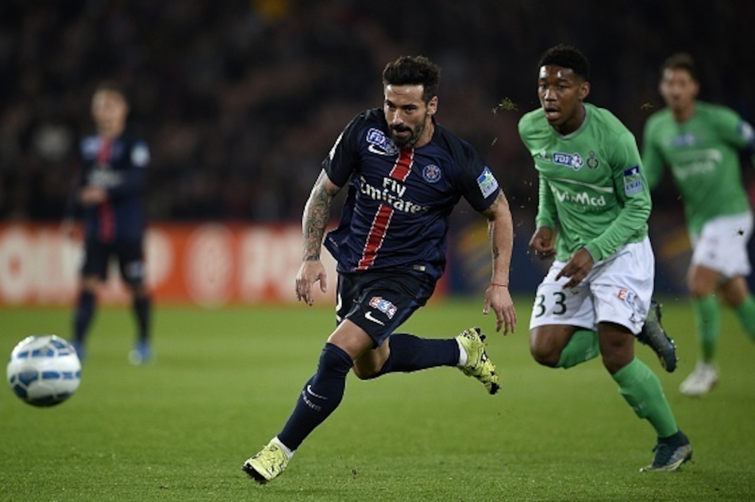 Paris Saint-Germain's Argentinian midfielder Ezequiel Lavezzi (L) eyes the ball during the French League Cup football match between Paris Saint-Germain (PSG) and Saint-Etienne (ASSE) at the Parc des Princes stadium in Paris on December 15, 2015. AFP PHOTO