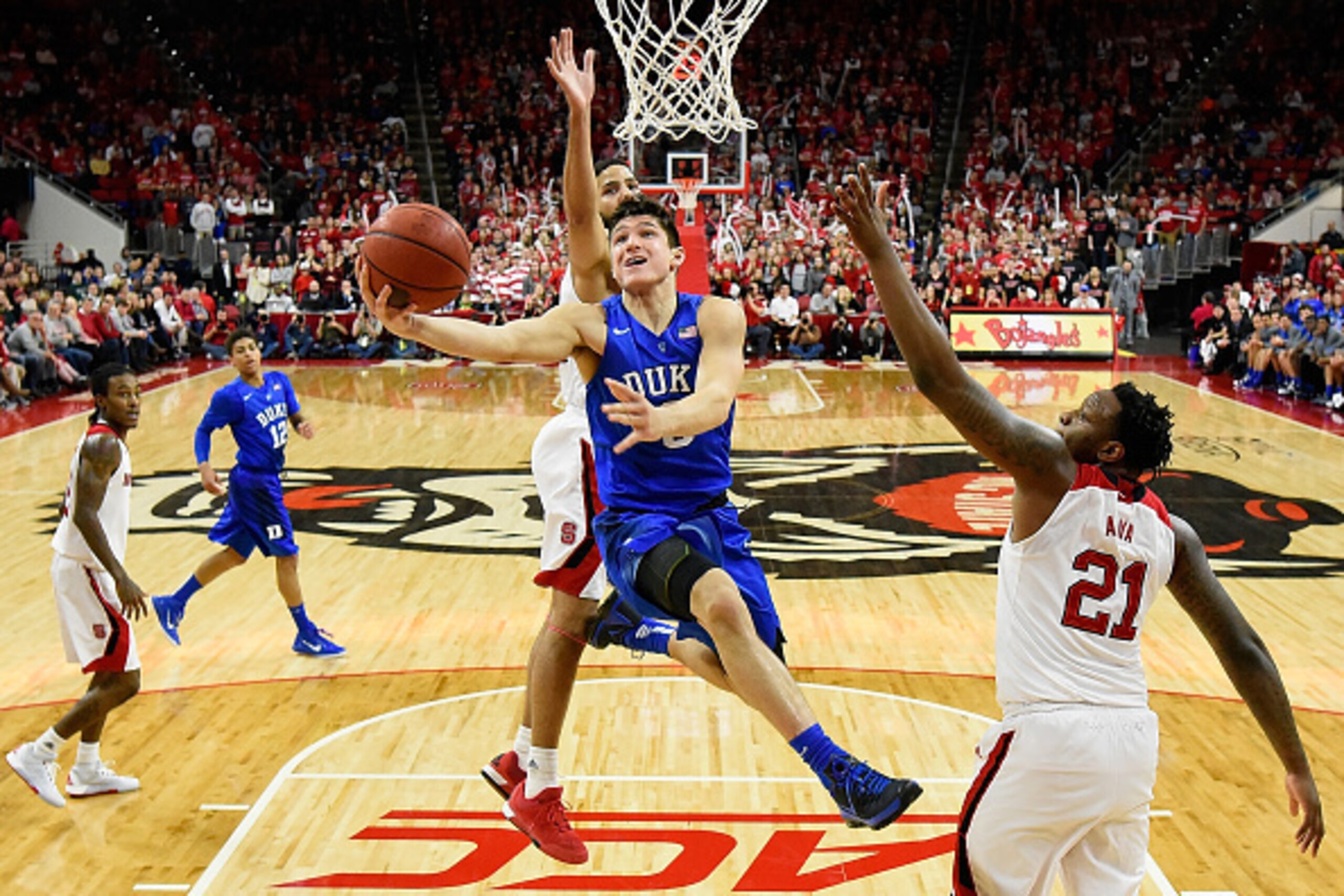 RALEIGH, NC - JANUARY 23:  Grayson Allen #3 of the Duke Blue Devils drives past Caleb Martin #14 of the North Carolina State Wolfpack during their game at PNC Arena on January 23, 2016 in Raleigh, North Carolina. Duke won 88-78.  (Photo by Grant Halverson