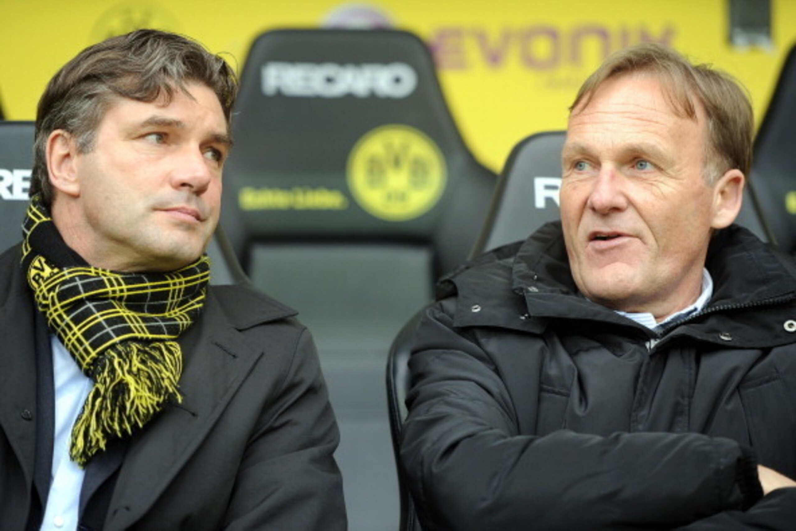 Dortmund's manager Michael Zorc (L) and Dortmund's managing director Hans-Joachim Watzke chat prior to the German first football division Bundesliga match between Borussia Dortmund and SC Freiburg in Dortmund, western Germany, on May 5, 2012.    AFP PHOTO