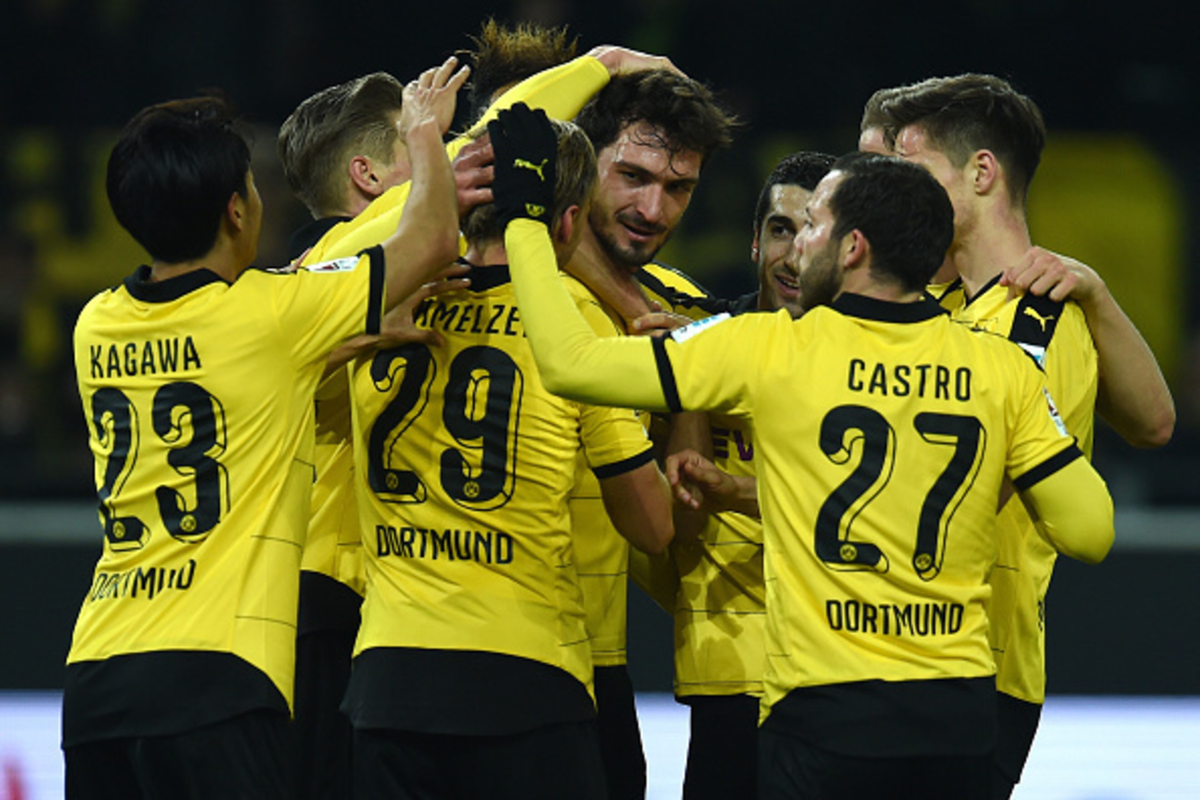 Dortmund's defender Mats Hummels (C, R) celebrates with teammates after scoring during the German first division Bundesliga football match Borussia Dortmund vs Eintracht Frankfurt in Dortmund, western Germany, on December 13, 2015. Dortmund won the match 
