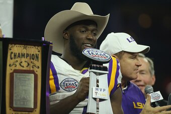 HOUSTON, TX - DECEMBER 29:  Leonard Fournette #7 of the LSU Tigers and his head coach Les Miles pose on stage after the Tigers beat the Texas Tech Red Raiders 56-27 during the AdvoCare V100 Texas Bowl at NRG Stadium on December 29, 2015 in Houston, Texas.