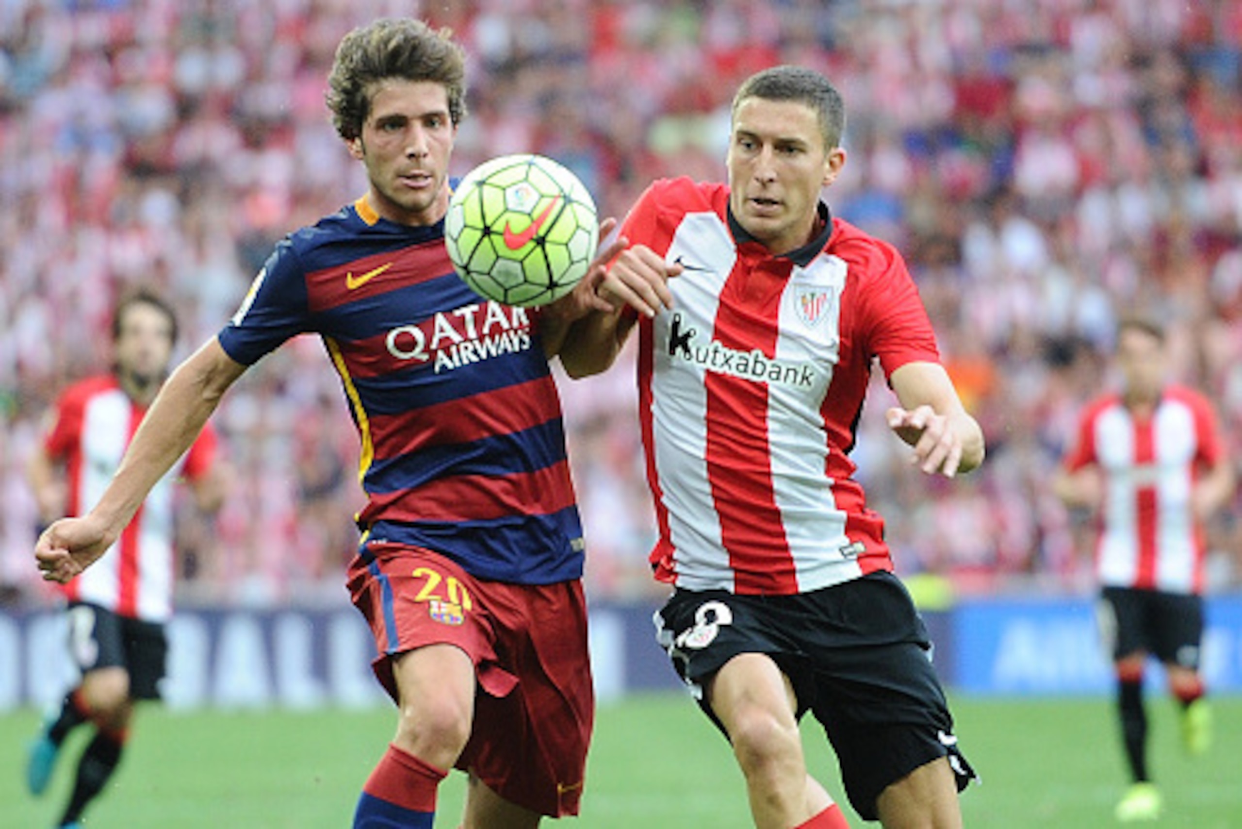 BILBAO, SPAIN - AUGUST 23: Sergi Roberto of FC Barcelona battles for the ball against Oscar de Marcos of Athletic Club during the La Liga match between Athletic Club and FC Barcelona at San Mames Stadium on August 23, 2015 in Bilbao, Spain.  (Photo by Den
