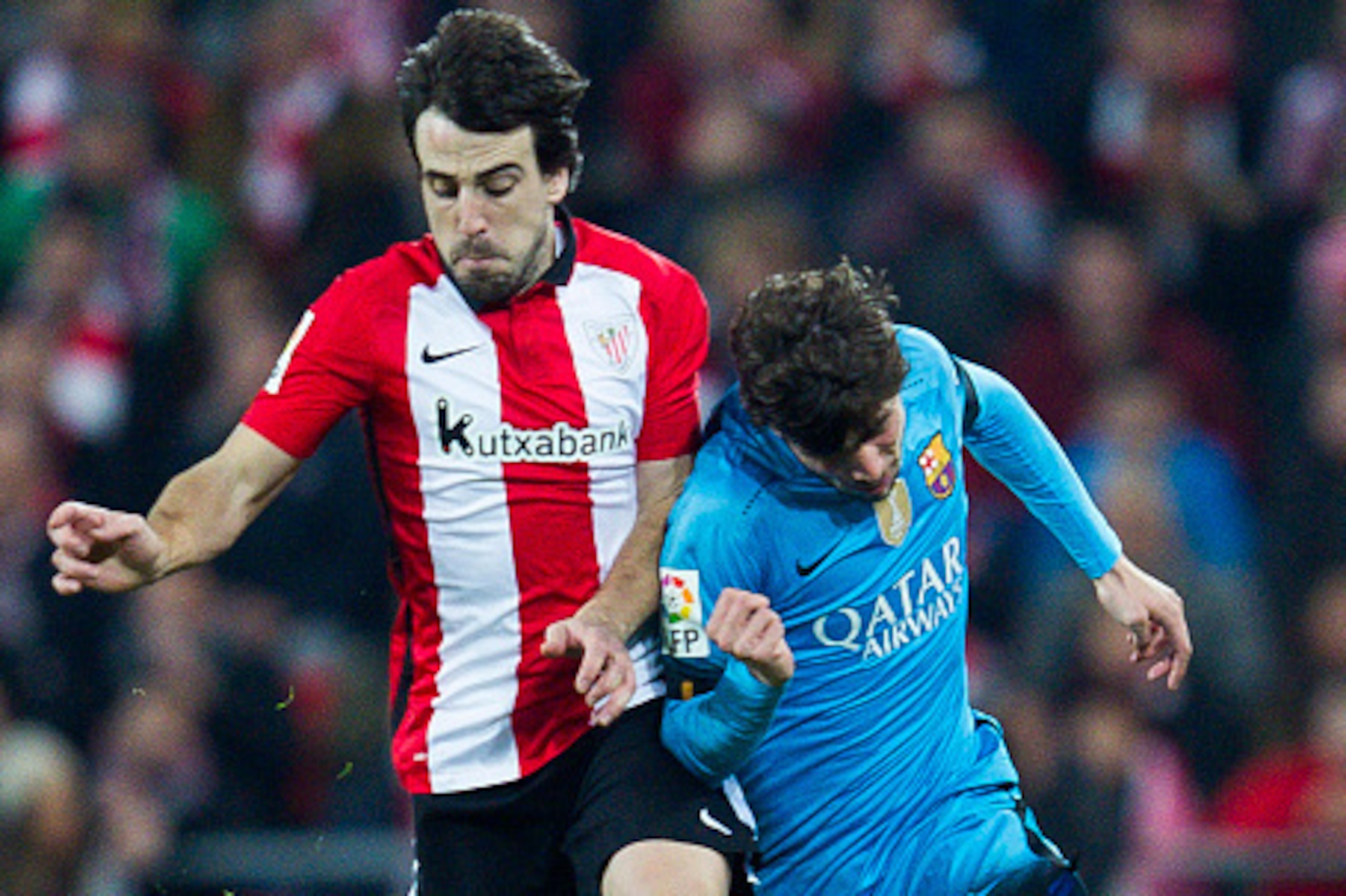BILBAO, SPAIN - JANUARY 20: Roberto Carnicer of FC Barcelola duels for the ball with Benat Etxebarria of Athletic Club during the Copa del Rey Quarter Final First Leg match between Athletic Club and FC Barcelola at San Mames Stadium on January 20, 2016 in