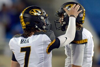 LEXINGTON, KY - SEPTEMBER 26:  Maty Mauk #7 of the Missouri Tigers pats Drew Lock #3 of the Missouri Tigers on the head during a timeout against the Kentucky Wildcats at Commonwealth Stadium on September 26, 2015 in Lexington, Kentucky. (Photo by Dylan Bu