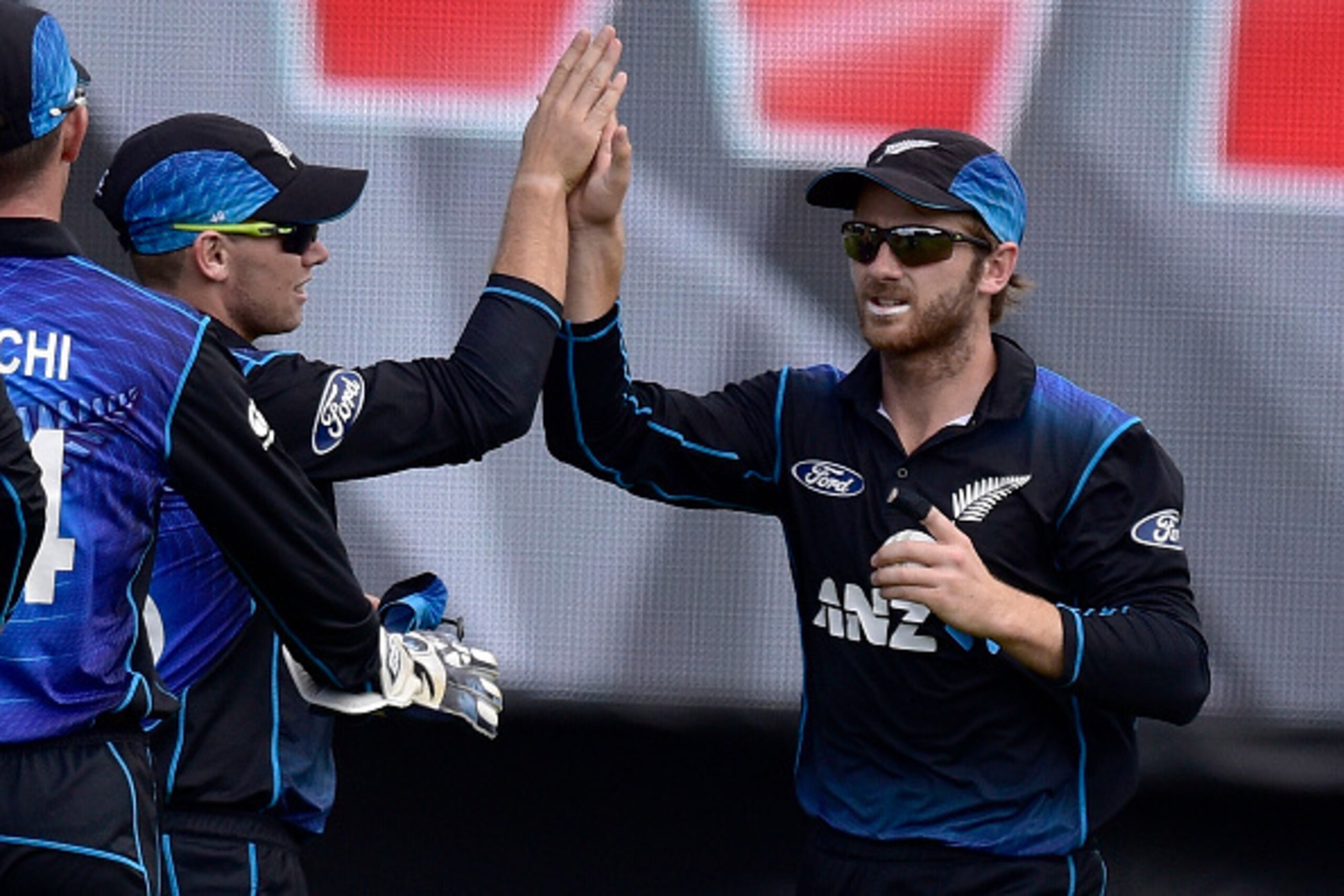 Kane Williamson (R) captain of New Zealand celebrates taking the catch of Ahmed Shehzad of Pakistan with teammate Tom Latham during the first one-day international between New Zealand and Pakistan at the Basin Reserve in Wellington on January 25, 2016.   