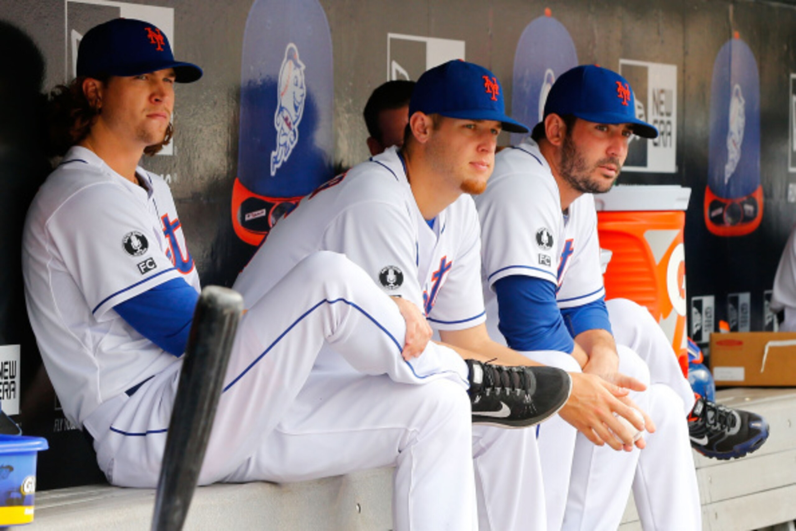 NEW YORK, NY - AUGUST 03:  (L-R) Jacob deGrom #48, Zack Wheeler #45 and Matt Harvey #33 of the New York Mets look on against the San Francisco Giants at Citi Field on August 3, 2014 in the Flushing neighborhood of the Queens borough of New York City. The 