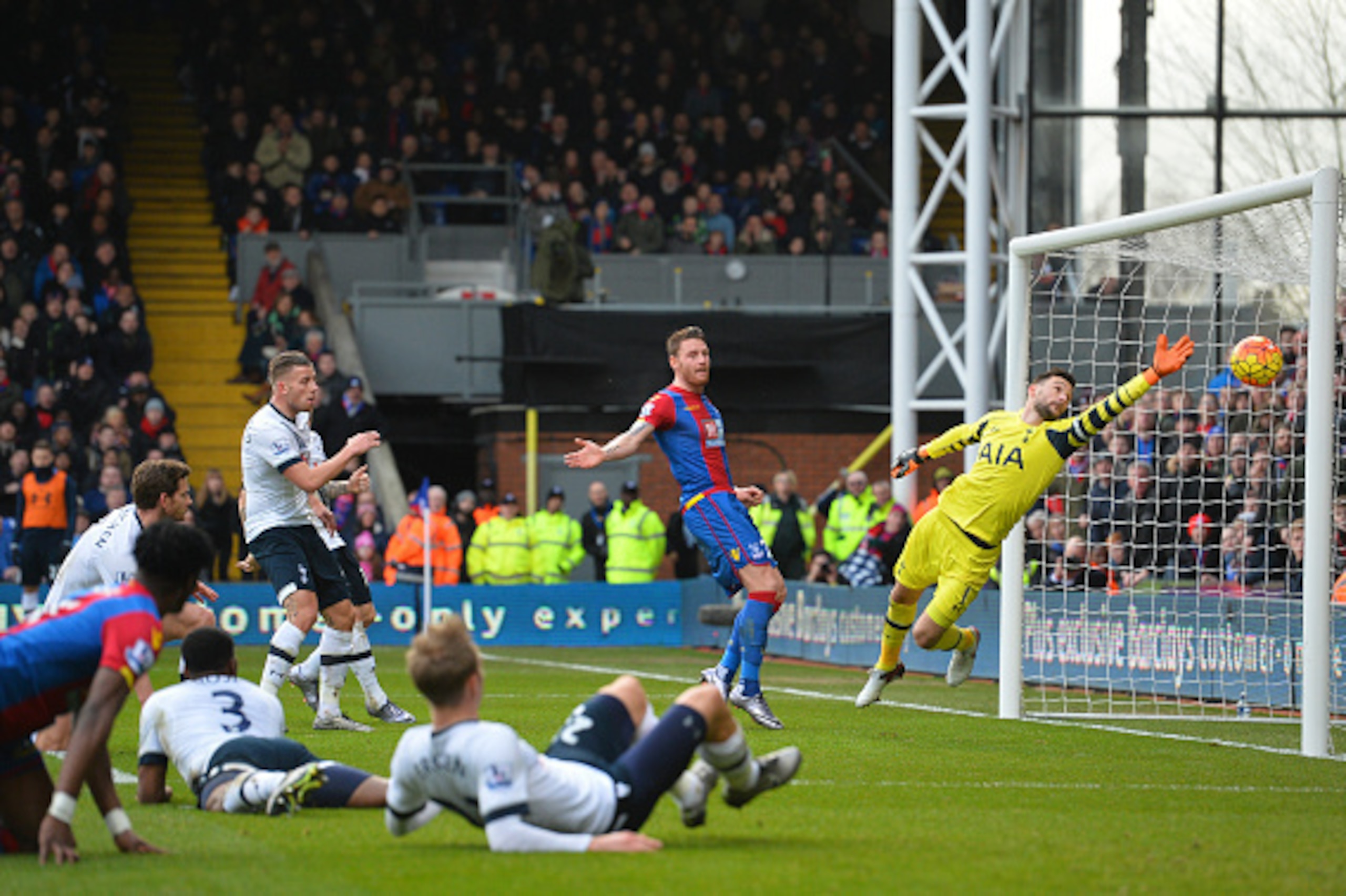 Tottenham Hotspur's French goalkeeper Hugo Lloris (R) dives but fails to stop the ball that is turned into the Tottenham net by Tottenham Hotspur's Belgian defender Jan Vertonghen (L) for an own goal from a cross from Crystal Palace's Ivorian-born English