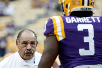 BATON ROUGE, LA - SEPTEMBER 13:  Defensive coordinator John Chavis of the LSU Tigers works with Clifton Garrett #3 prior to a game against the Louisiana Monroe Warhawks at Tiger Stadium on September 13, 2014 in Baton Rouge, Louisiana.  LSU won the game 31