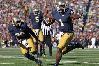 SOUTH BEND, IN - OCTOBER 11: Greg Bryant #1 of the Notre Dame Fighting Irish runs for a touchdown in front of C.J. Prosise #20 as Evertt Golson #5 signals the score against the North Carolina Tar Heels at Notre Dame Stadium on October 11, 2014 in South Be