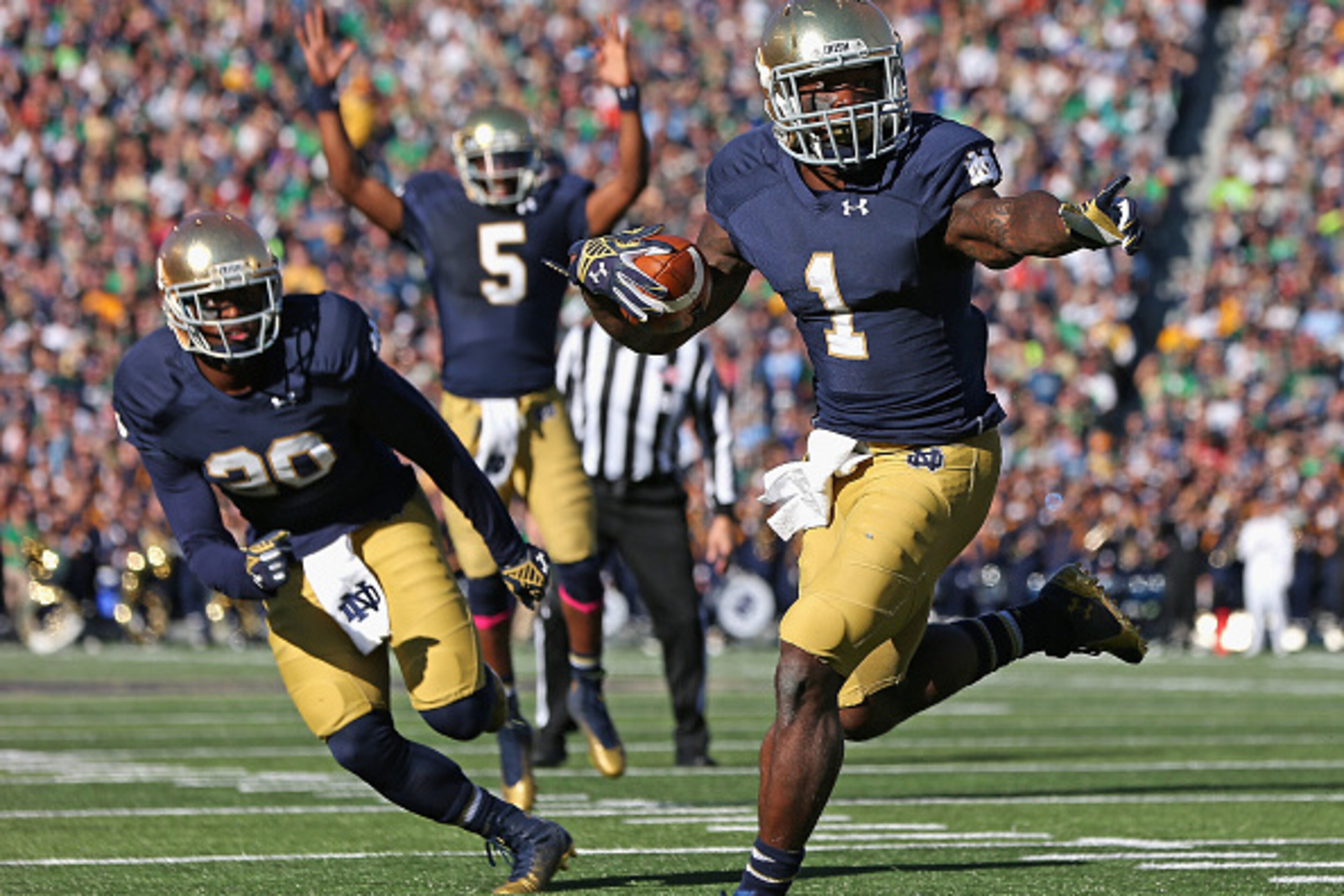 SOUTH BEND, IN - OCTOBER 11: Greg Bryant #1 of the Notre Dame Fighting Irish runs for a touchdown in front of C.J. Prosise #20 as Evertt Golson #5 signals the score against the North Carolina Tar Heels at Notre Dame Stadium on October 11, 2014 in South Be SOUTH BEND, IN - OCTOBER 11: Greg Bryant #1 of the Notre Dame Fighting Irish runs for a touchdown in front of C.J. Prosise #20 as Evertt Golson #5 signals the score against the North Carolina Tar Heels at Notre Dame Stadium on October 11, 2014 in South Be