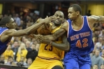 Dec 23, 2015; Cleveland, OH, USA; Cleveland Cavaliers forward LeBron James (23) drives between New York Knicks forward Lance Thomas (42) and guard Langston Galloway (2) in the fourth quarter at Quicken Loans Arena. Mandatory Credit: David Richard-USA TODA