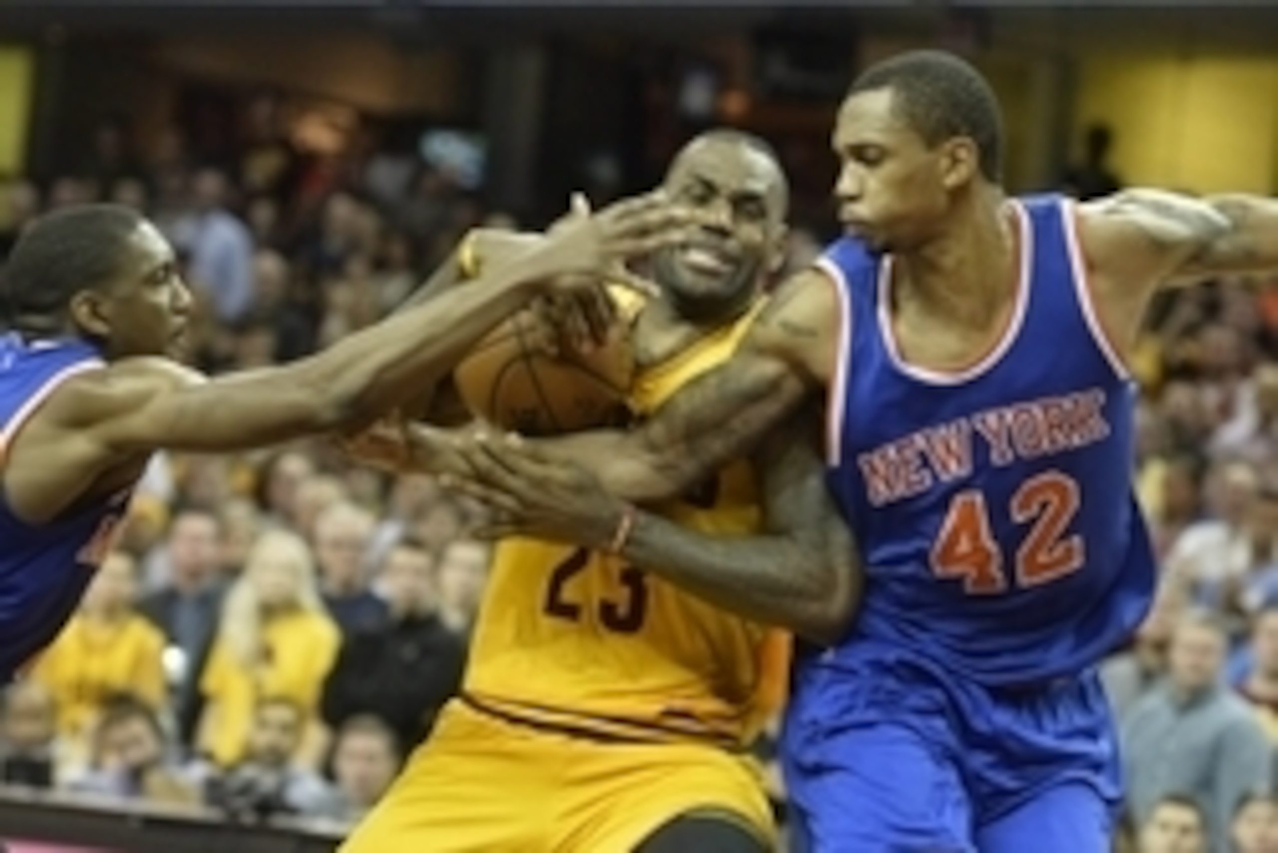 Dec 23, 2015; Cleveland, OH, USA; Cleveland Cavaliers forward LeBron James (23) drives between New York Knicks forward Lance Thomas (42) and guard Langston Galloway (2) in the fourth quarter at Quicken Loans Arena. Mandatory Credit: David Richard-USA TODA