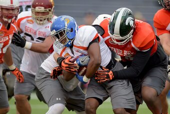 Jan 26, 2016; Mobile, AL, USA; North squad running back Tyler Ervin of San Jose State (7) is stopped by defensive end Lawrence Thomas of Michigan State (98) during Senior Bowl practice at Ladd-Peebles Stadium. Mandatory Credit: Glenn Andrews-USA TODAY Spo