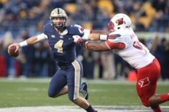 Nov 21, 2015; Pittsburgh, PA, USA; Pittsburgh Panthers quarterback Nathan Peterman (4) runs with the ball as Louisville Cardinals defensive end Sheldon Rankins (98) defends during the second quarter at Heinz Field. Mandatory Credit: Charles LeClaire-USA T