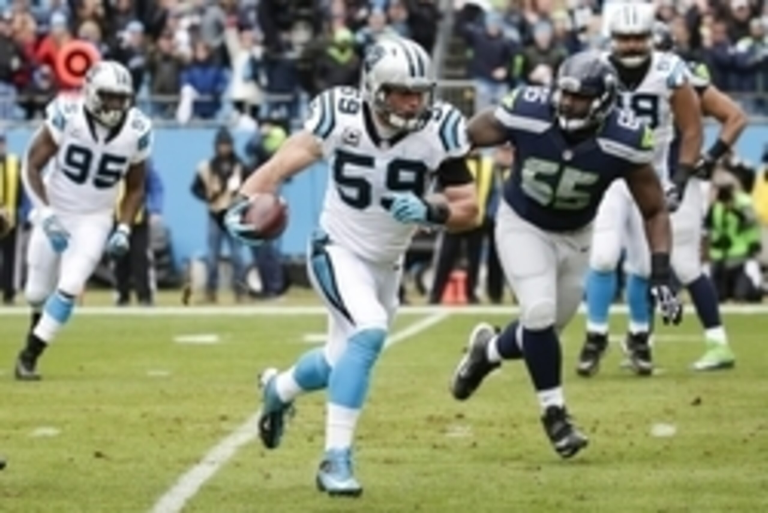 Jan 17, 2016; Charlotte, NC, USA; Carolina Panthers middle linebacker Luke Kuechly (59) runs the ball for a touchdown past Seattle Seahawks center Patrick Lewis (65) during the first quarter in a NFC Divisional round playoff game at Bank of America Stadiu Jan 17, 2016; Charlotte, NC, USA; Carolina Panthers middle linebacker Luke Kuechly (59) runs the ball for a touchdown past Seattle Seahawks center Patrick Lewis (65) during the first quarter in a NFC Divisional round playoff game at Bank of America Stadiu