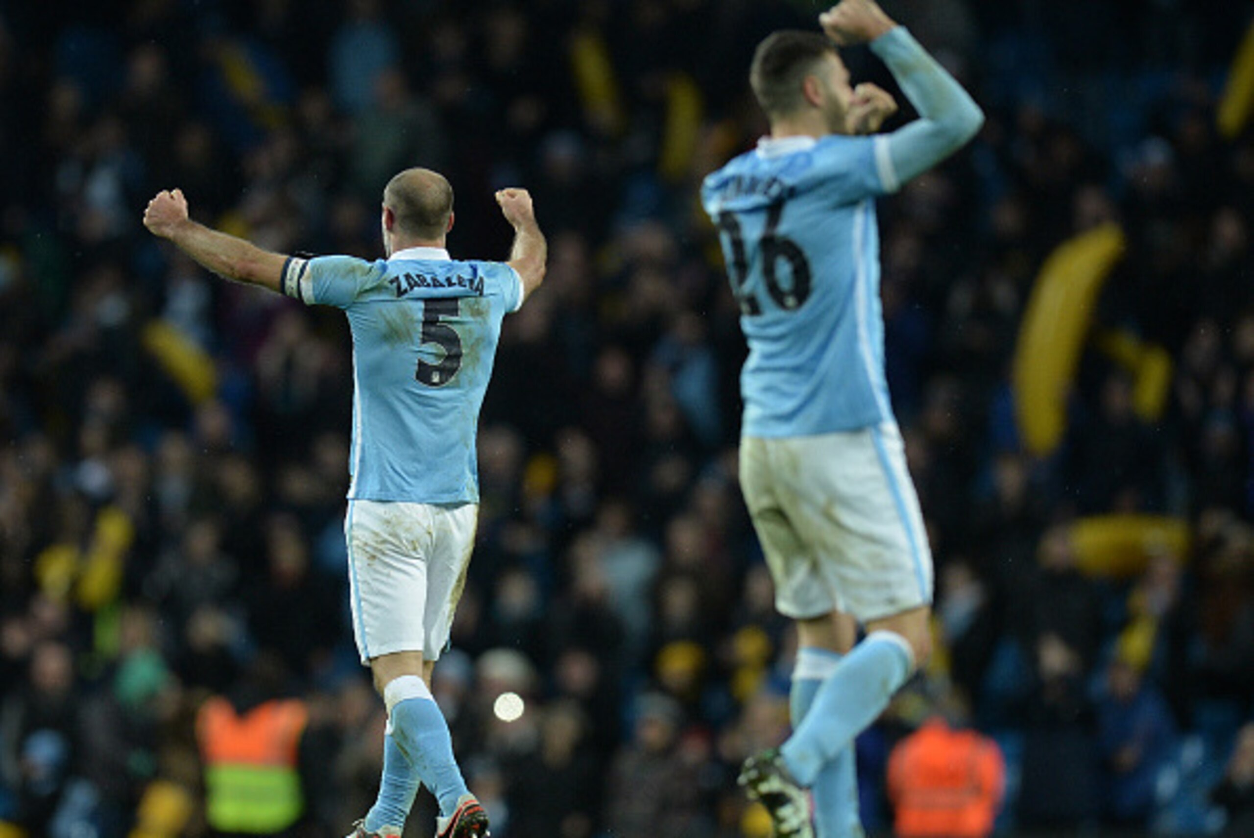 Manchester City's Argentinian defender Martin Demichelis (R) and Manchester City's Argentinian defender Pablo Zabaleta celebrate at the final whistle during the English League Cup semi-final second leg football match between Manchester City and Everton th