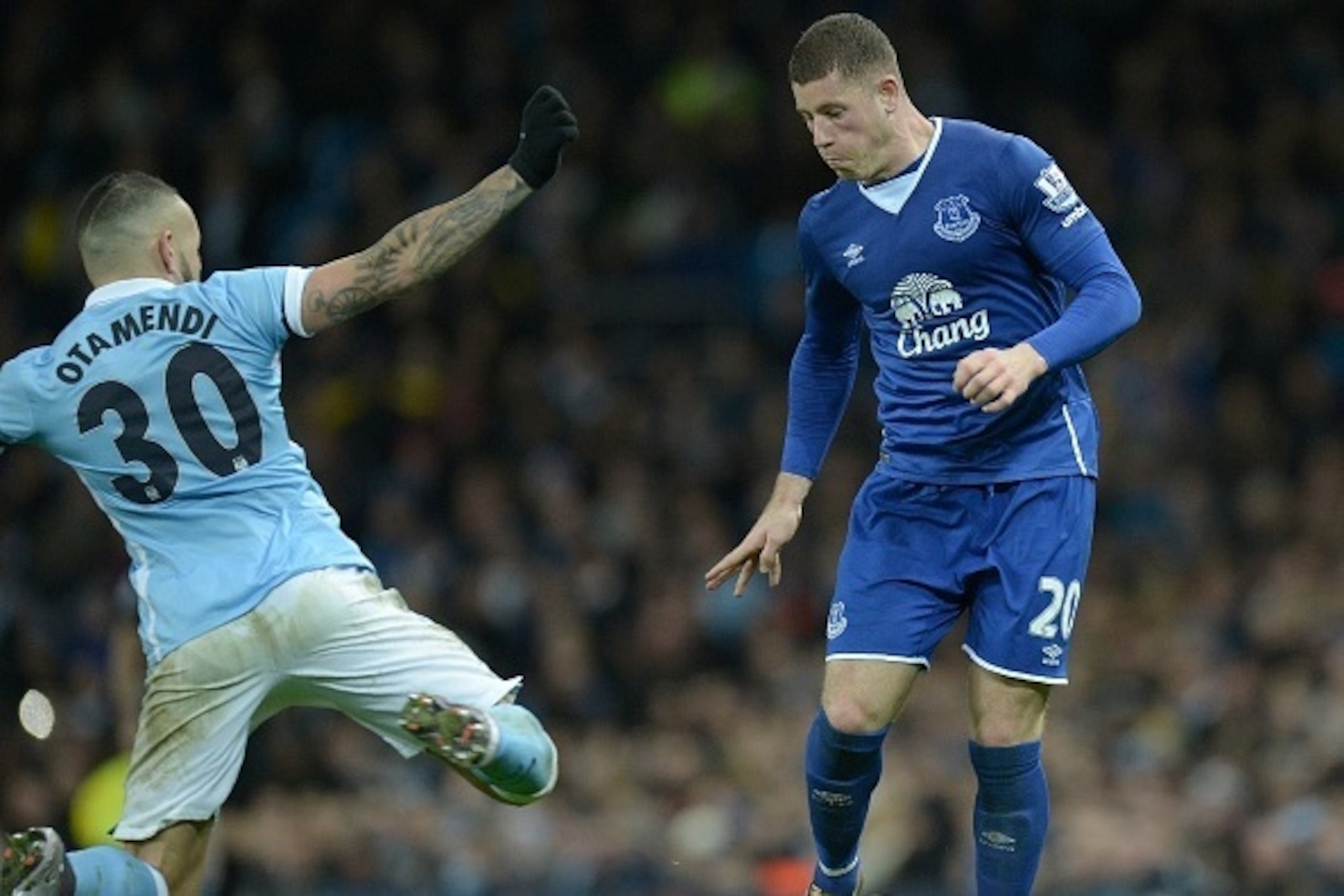 Manchester City's Argentinian defender Nicolas Otamendi (L) challenges Everton's English midfielder Ross Barkley during the English League Cup semi-final second leg football match between Manchester City and Everton the Etihad Stadium in Manchester, north