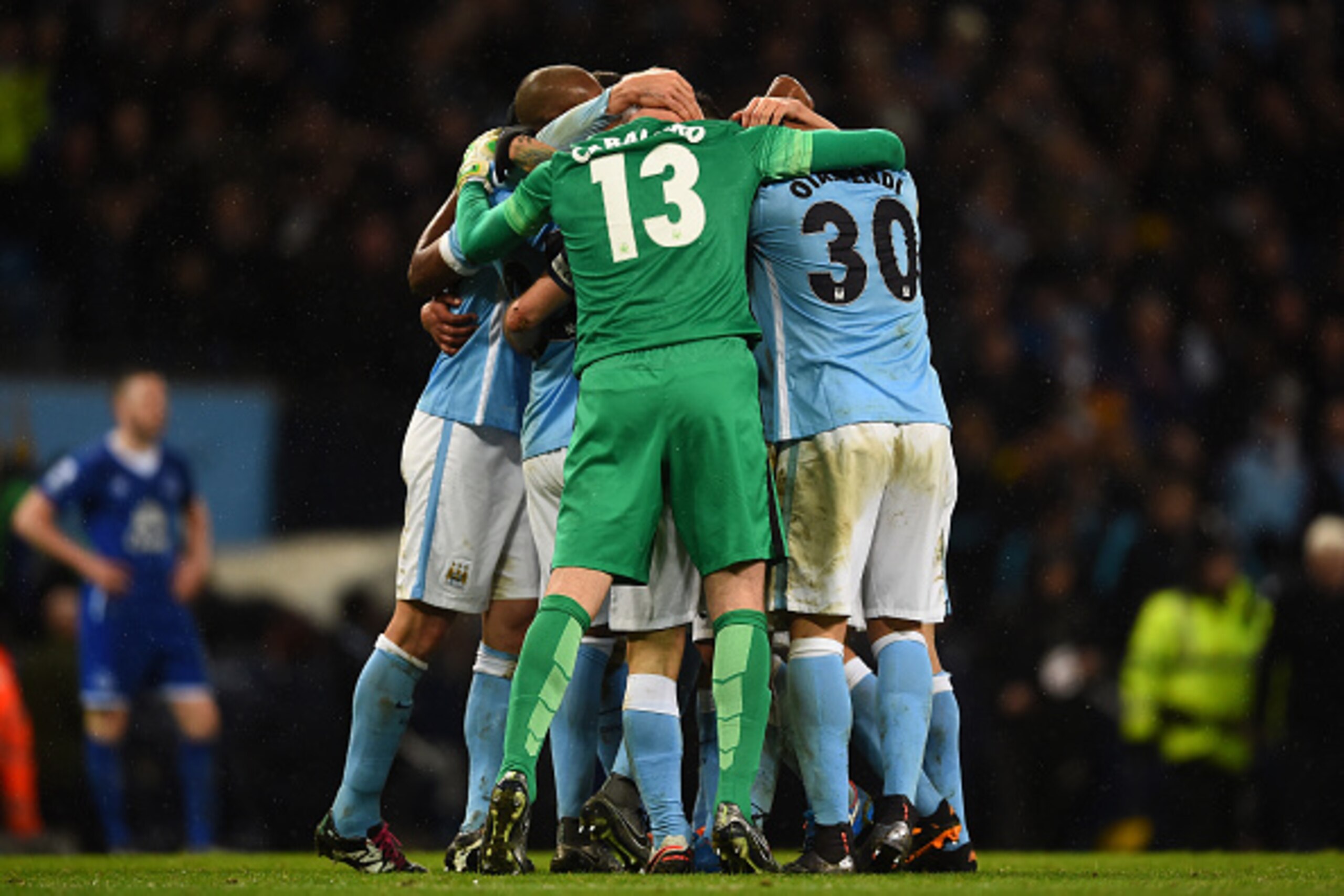 MANCHESTER, ENGLAND - JANUARY 27:  Manchester City teammates celebrate their team's 3-1 victory and progression to the final during the Capital One Cup Semi Final, second leg match between Manchester City and Everton at the Etihad Stadium on January 27, 2