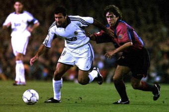 21 Oct 2000: Luis Figo of Real Madrid gets away from Carles Puyol of Barcelona during the Spanish Primera Liga match between Barcelona and Real Madrid at the Nou Camp in Barcelona, Spain. Mandatory Credit: Allsport/ALLSPORT