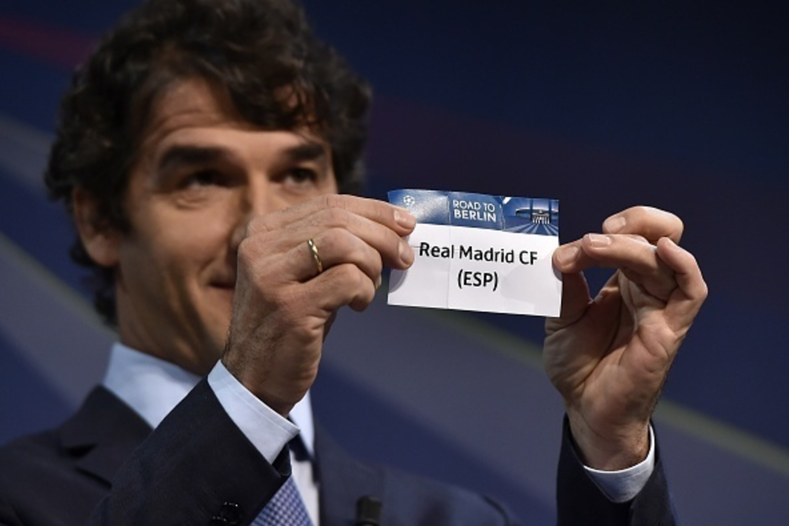 The ambassador for the UEFA Champions League final in Berlin Karl-Heinz Riedle presents the name Real Madrid CF during the draw for the UEFA Champions League round of 16 on December 15, 2014 at the UEFA headquarters in Nyon.  AFP PHOTO / FABRICE COFFRINI 