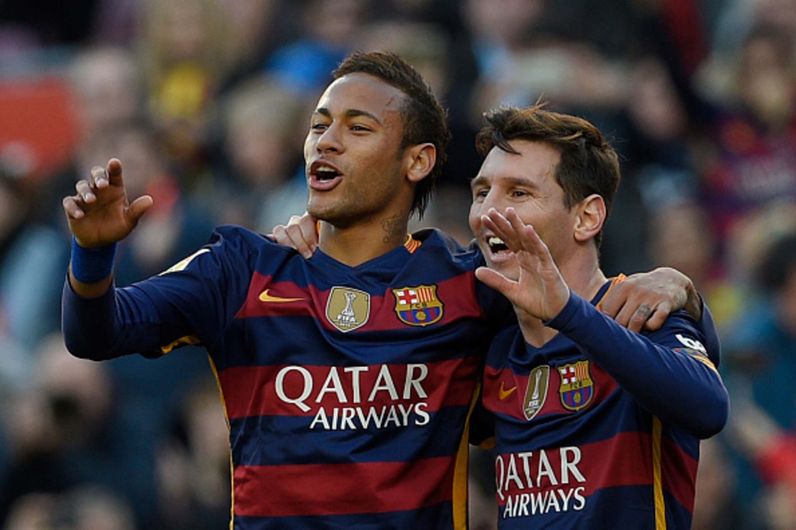 Barcelona's Argentinian forward Lionel Messi (R) celebrates a goal with Barcelona's Brazilian forward Neymar (L) during the Spanish league football match FC Barcelona vs Granada CF at the Camp Nou stadium in Barcelona on January 9, 2016.   AFP PHOTO / LLU