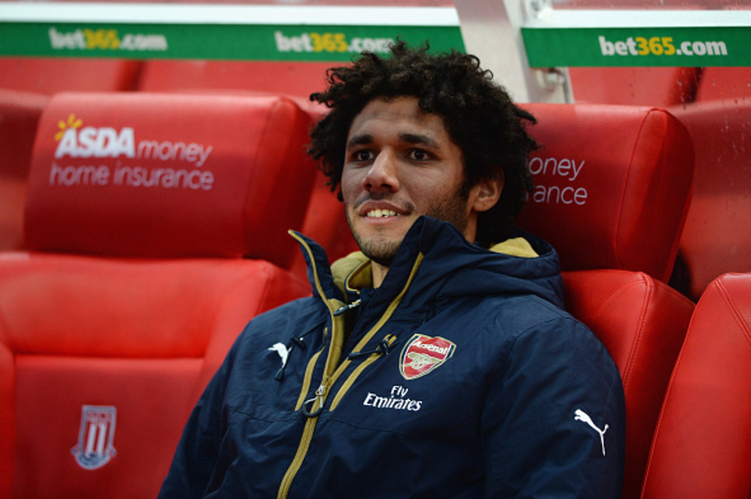 STOKE ON TRENT, ENGLAND - JANUARY 17: Mohamed Elneny of Arsenal sits on the bench prior to the Barclays Premier League match between Stoke City and Arsenal at Britannia Stadium on January 17, 2016 in Stoke on Trent, England. (Photo by Gareth Copley/Gett STOKE ON TRENT, ENGLAND - JANUARY 17: Mohamed Elneny of Arsenal sits on the bench prior to the Barclays Premier League match between Stoke City and Arsenal at Britannia Stadium on January 17, 2016 in Stoke on Trent, England. (Photo by Gareth Copley/Gett