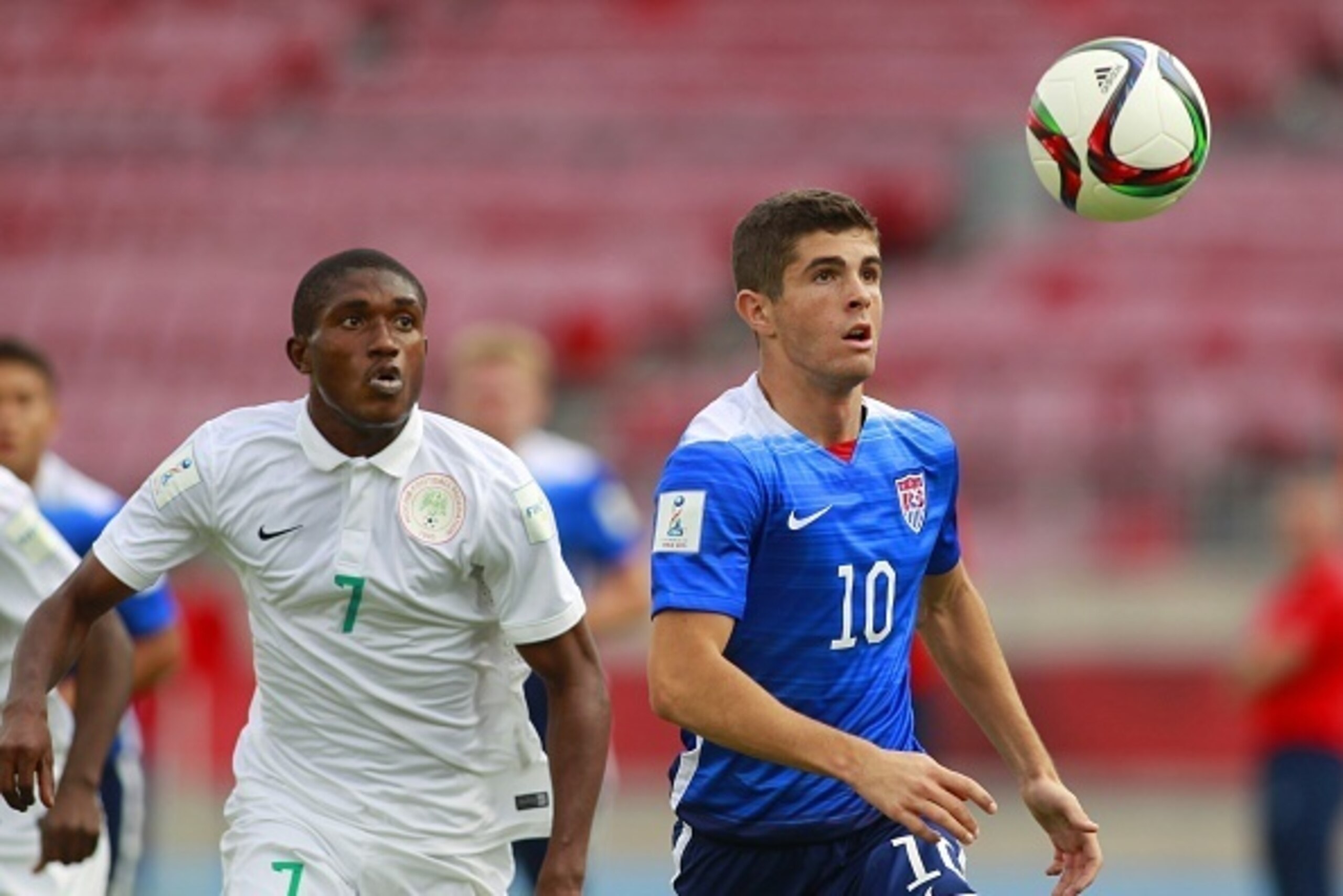 US player Christian Pulisic (R) and Nigeria's Funsho Bamgboye (L) vie for the ball  during an Under 17 World Cup football match between Nigeria and the United States at the  National Stadium  in Santiago on October 17, 2015.AFP PHOTO/MARCELO HERNANDEZ /PH