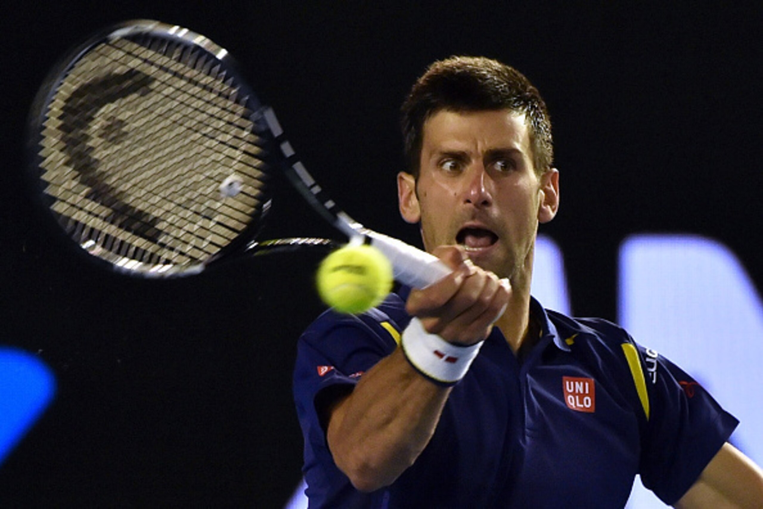 Serbia's Novak Djokovic hits a return during his men's singles semi-final match against Switzerland's Roger Federer on day eleven of the 2016 Australian Open tennis tournament in Melbourne on January 28, 2016. AFP PHOTO / PAUL CROCK-- IMAGE RESTRICTED TO
