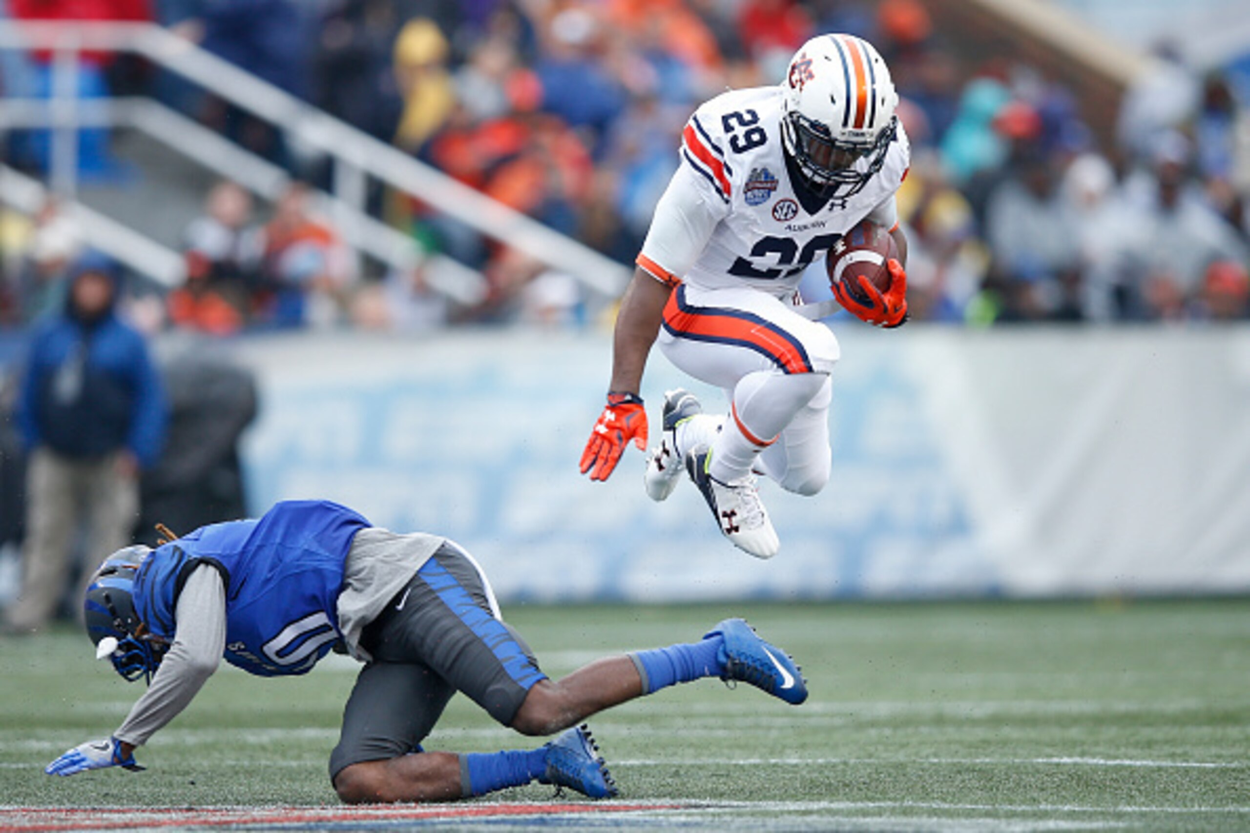 BIRMINGHAM, AL - DECEMBER 30: Jovon Robinson #29 of the Auburn Tigers jumps over a tackle attempt by Dontrell Nelson #10 of the Memphis Tigers in the first half of the Birmingham Bowl at Legion Field on December 30, 2015 in Birmingham, Alabama. (Photo by BIRMINGHAM, AL - DECEMBER 30: Jovon Robinson #29 of the Auburn Tigers jumps over a tackle attempt by Dontrell Nelson #10 of the Memphis Tigers in the first half of the Birmingham Bowl at Legion Field on December 30, 2015 in Birmingham, Alabama. (Photo by