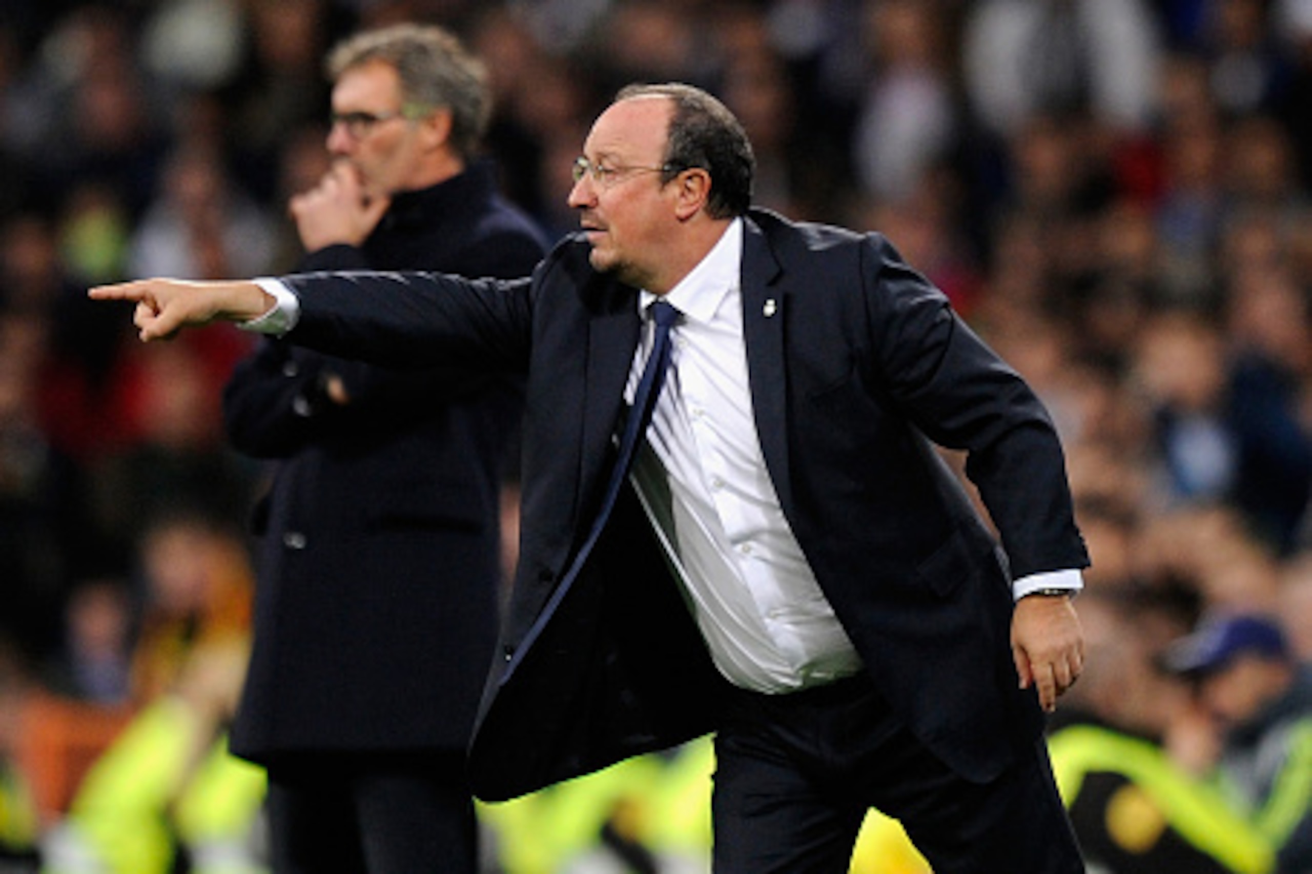 MADRID, SPAIN - NOVEMBER 03:  Rafa Benitez manager of Real Madrid signals as Laurent Blanc head coach of PSG looks on during the UEFA Champions League Group A match between Real Madrid CF and Paris Saint-Germain at Estadio Santiago Bernabeu on November 3,