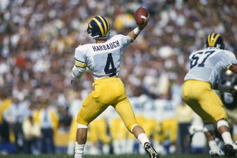 NOTRE DAME, IN - CIRCA 1986: Quarterback Jim Harbaugh #4 of the Michigan Wolverines drops back to pass against the Notre Dame Fighting Irish during an NCAA football game September 13, 1986 at Notre Dame Stadium in Notre Dame, Indiana. (Photo by Focus on S