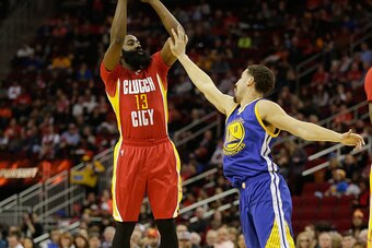 HOUSTON, TX - DECEMBER 31:  James Harden #13 of the Houston Rockets shoots over Klay Thompson #11 of the Golden State Warriors at Toyota Center on December 31, 2015 in Houston, Texas. NOTE TO USER: User expressly acknowledges and agrees that, by downloadi