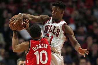 CHICAGO, IL - DECEMBER 28: Jimmy Butler #21 of the Chicago Bulls blocks a shot by DeMar DeRozan #10 of the Toronto Raptors at the United Center on December 28, 2015 in Chicago, Illinois. The Bulls defeated the Raptors 104-97. NOTE TO USER: User expressly 