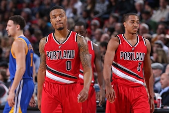 PORTLAND, OR - JANUARY 8:  Damian Lillard #0 and C.J. McCollum #3 of the Portland Trail Blazers walk off the court against the Golden State Warriors on January 8, 2016 at the Moda Center Arena in Portland, Oregon. NOTE TO USER: User expressly acknowledges