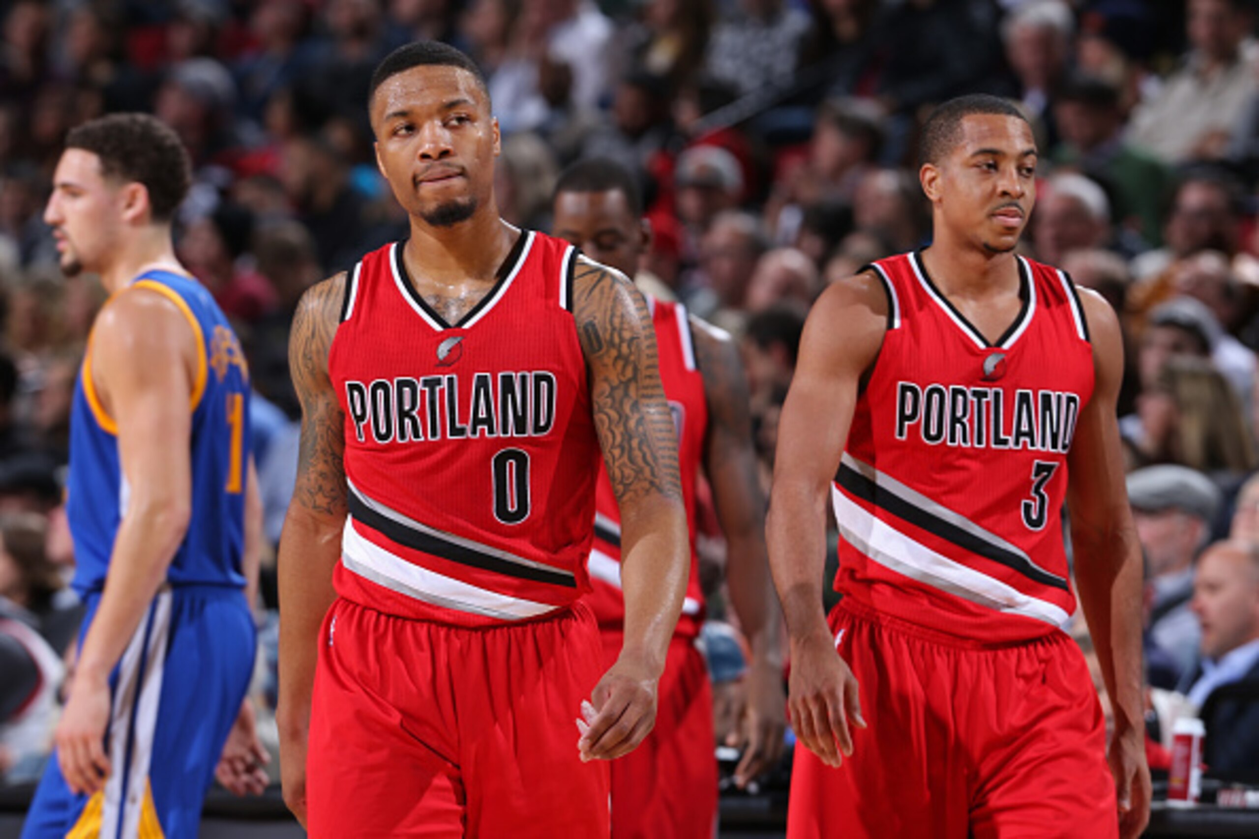 PORTLAND, OR - JANUARY 8:  Damian Lillard #0 and C.J. McCollum #3 of the Portland Trail Blazers walk off the court against the Golden State Warriors on January 8, 2016 at the Moda Center Arena in Portland, Oregon. NOTE TO USER: User expressly acknowledges