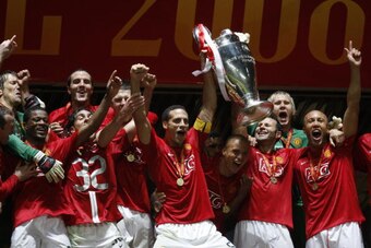 Manchester United's English defender Rio Ferdinand (C) holds up the trophy after beating Chelsea in the final of the Champions League football match at the Luzhniki stadium in Moscow on May 21, 2008. The match remained at a 1-1 draw and Manchester won on 