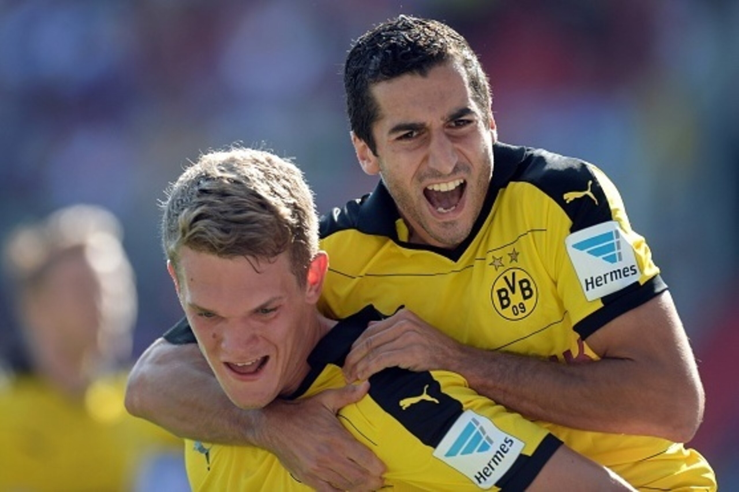 Dortmund's defender Matthias Ginter (L) and his teammate Dortmund's Armenian midfielder Henrikh Mkhitaryan (R) celebrate after the first goal for Dortmund during the German first division Bundesliga football match FC Ingolstadt 04 vs Borussia Dortmund, on