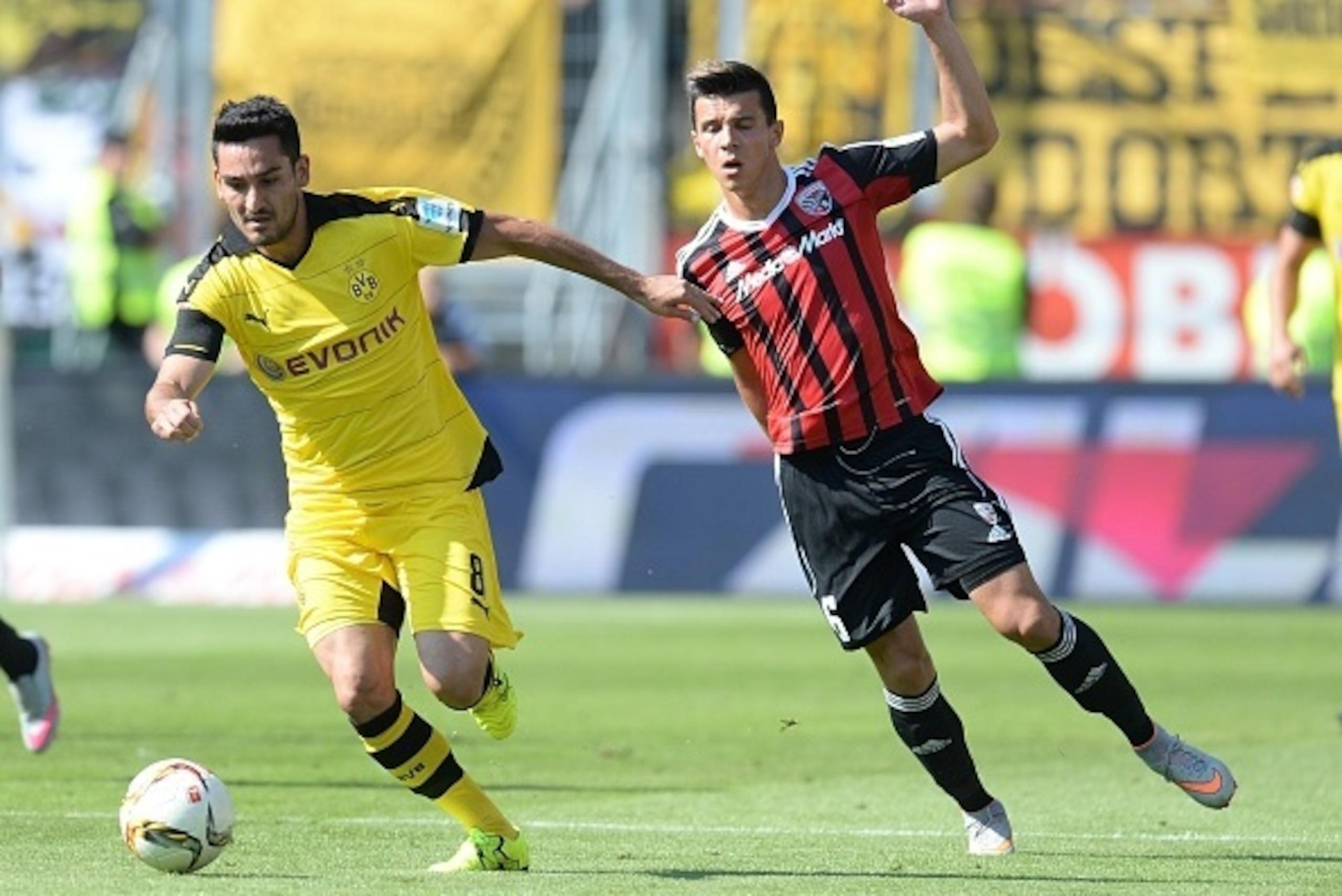 Dortmund's midfielder Ilkay Guendogan (L) and Ingolstadt's US midfielder Alfredo Morales (R) vie for the ball during the German first division Bundesliga football match FC Ingolstadt 04 vs Borussia Dortmund, on August 23, 2015 in Ingolstadt.  AFP PHOTO / 